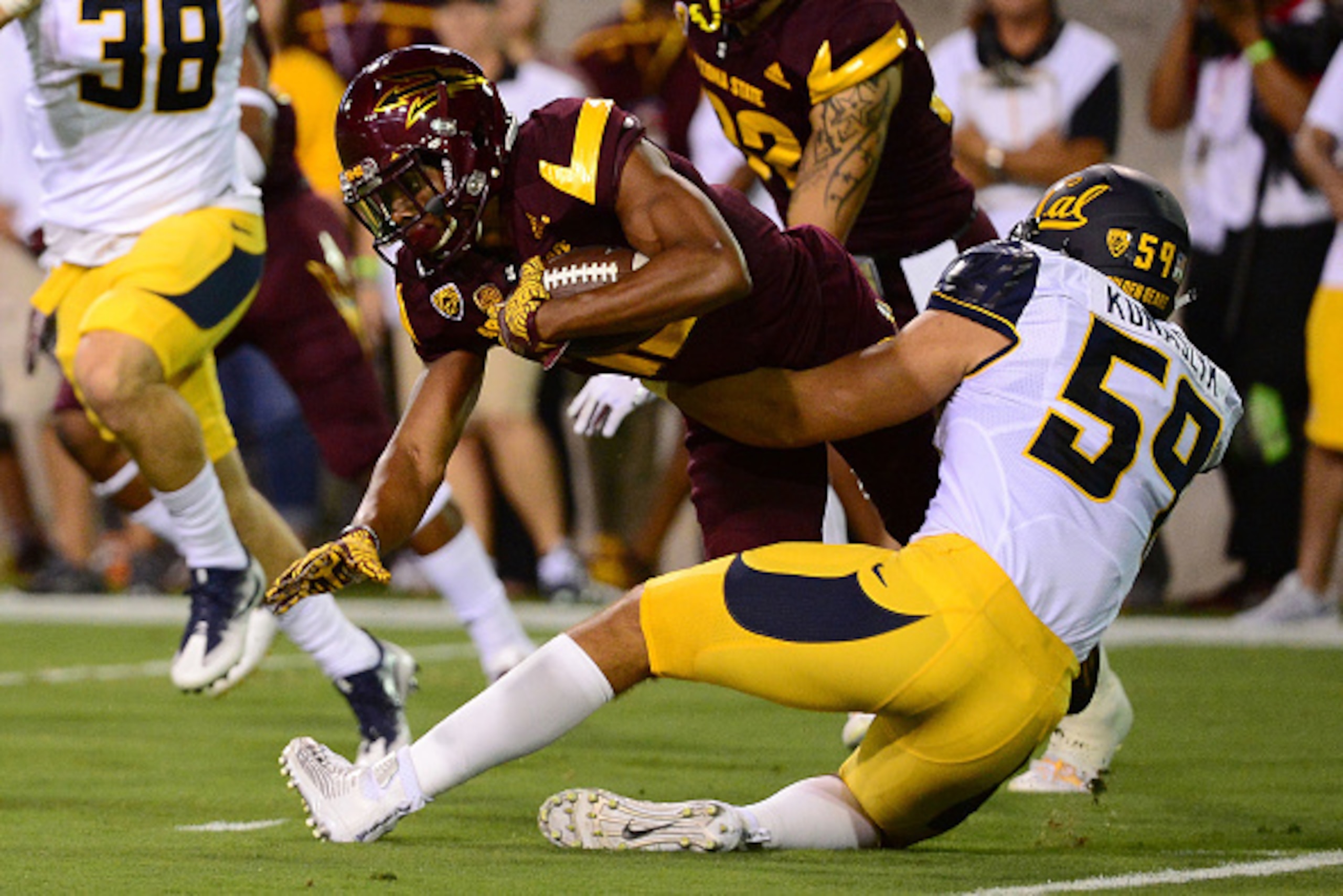 TEMPE, AZ - SEPTEMBER 24:  Wide receiver Tim White #12 of the Arizona State Sun Devils is tackled by linebacker Jordan Kunaszyk #59 of the California Golden Bears in the first half at Sun Devil Stadium on September 24, 2016 in Tempe, Arizona.  (Photo by J