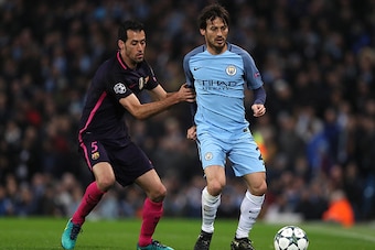 MANCHESTER, ENGLAND - NOVEMBER 01:  David Silva of Manchester City competes with Sergio Busquets of Barcelona during the UEFA Champions League match between Manchester City FC and FC Barcelona at Etihad Stadium on November 1, 2016 in Manchester, England. 
