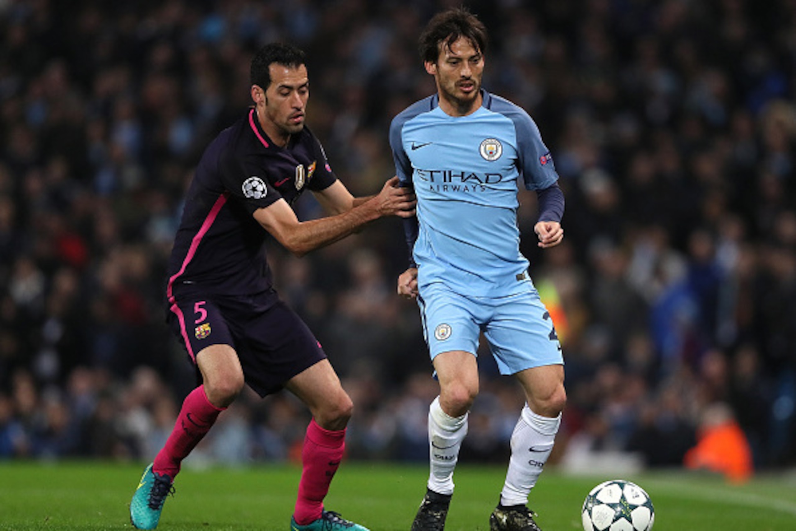 MANCHESTER, ENGLAND - NOVEMBER 01:  David Silva of Manchester City competes with Sergio Busquets of Barcelona during the UEFA Champions League match between Manchester City FC and FC Barcelona at Etihad Stadium on November 1, 2016 in Manchester, England. 