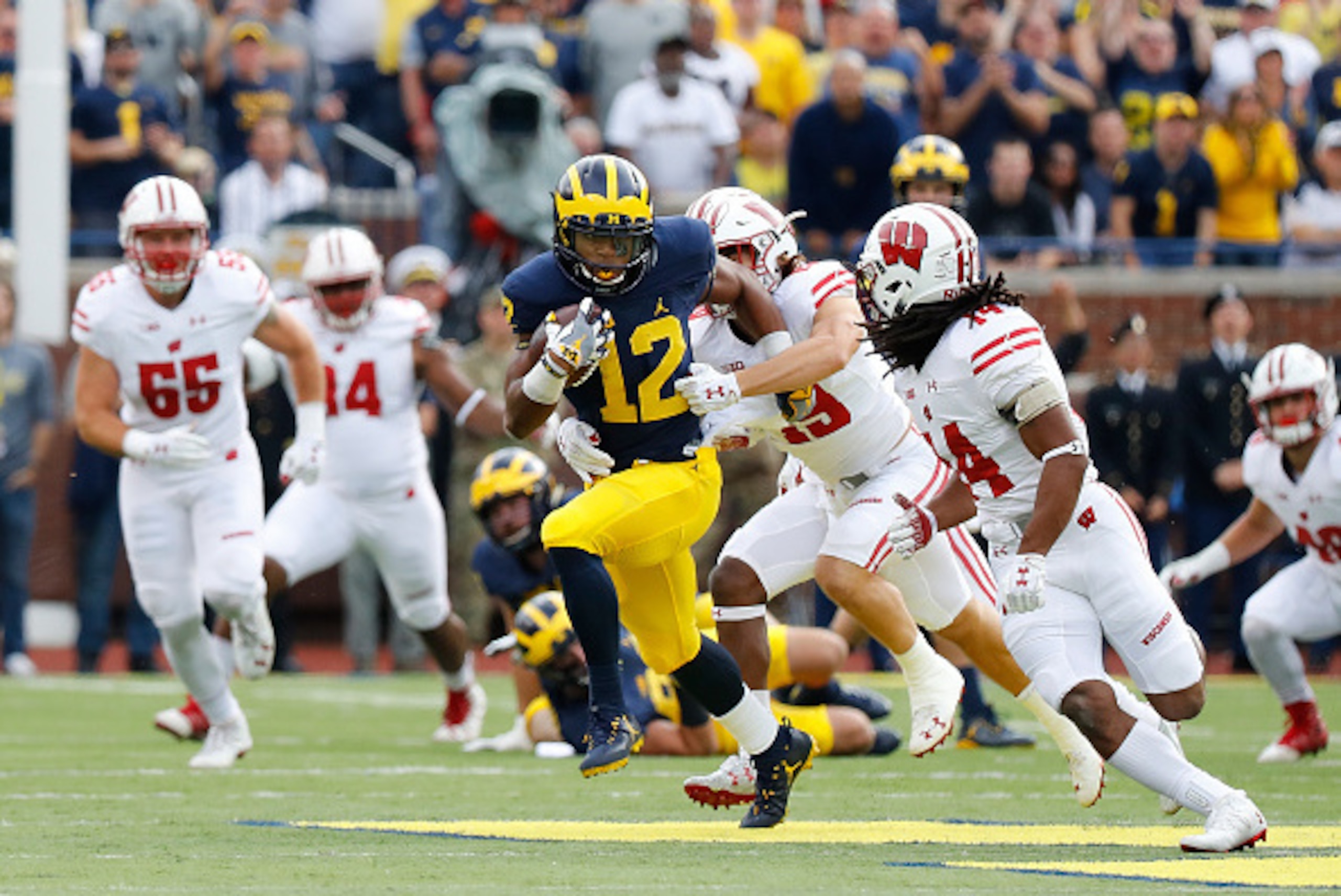 ANN ARBOR, MI - OCTOBER 01: Chris Evans #12 of the Michigan Wolverines runs for a first down during the first quarter of the game against the Wisconsin Badgers at Michigan Stadium on October 1, 2016 in Ann Arbor, Michigan. (Photo by Leon Halip/Getty Image