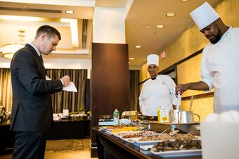 Ravens team operations assistant David Ghostlaw checks on the food ahead of a team meal in Philadelphia.