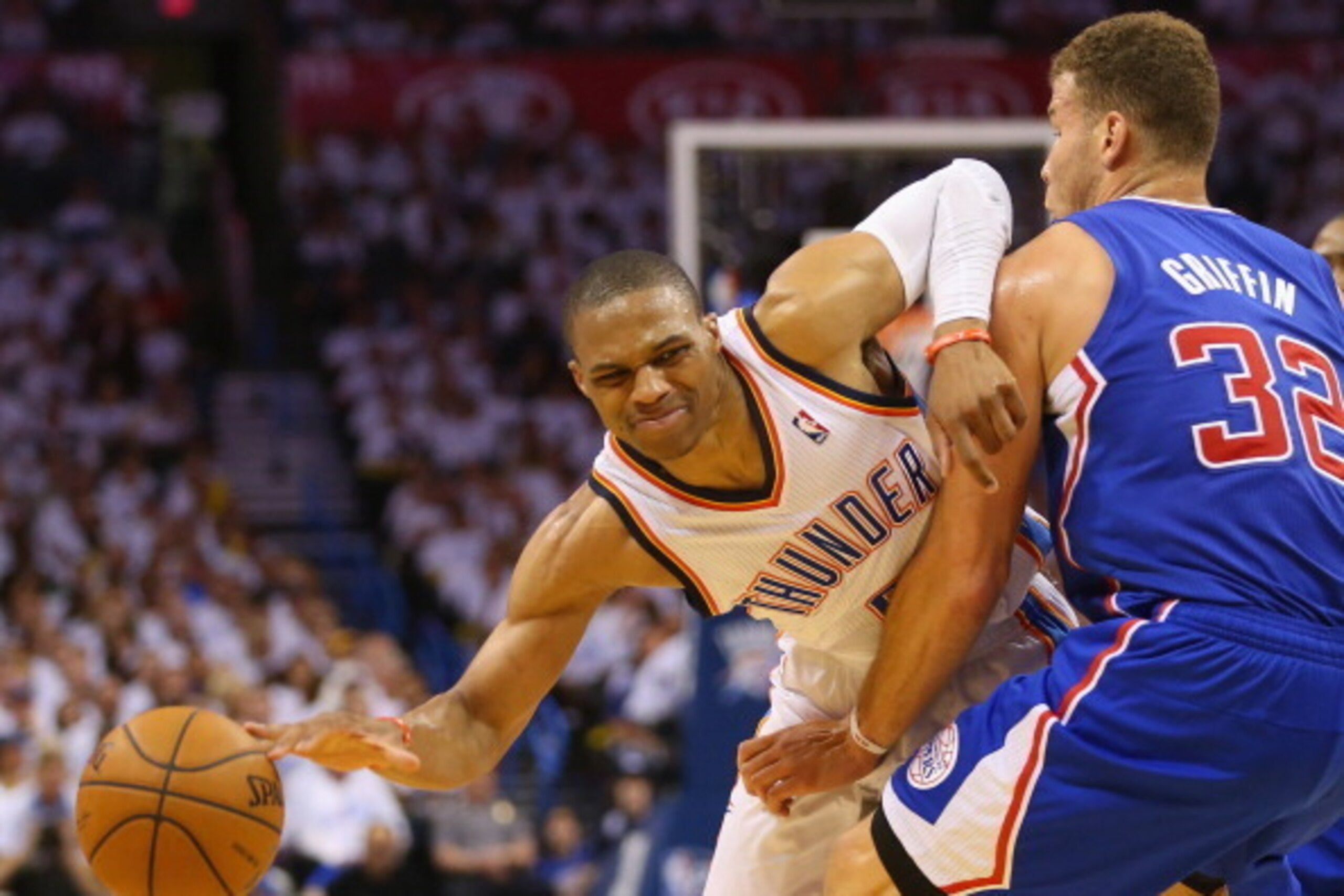OKLAHOMA CITY, OK - MAY 13:  Russell Westbrook #0 of the Oklahoma City Thunder dribbles the ball against Blake Griffin #32 of the Los Angeles Clippers in Game Five of the Western Conference Semifinals during the 2014 NBA Playoffs at Chesapeake Energy Aren
