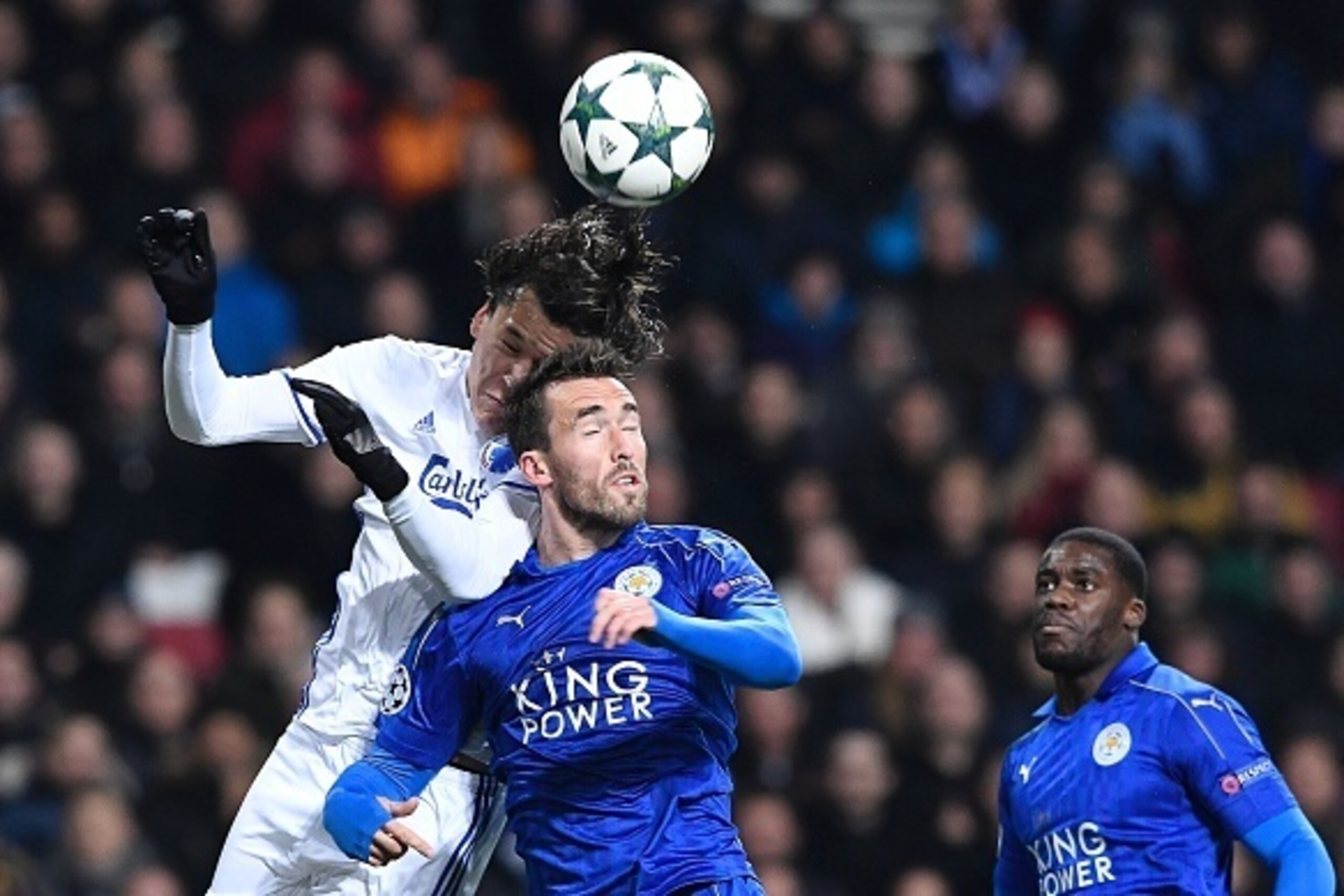 Leicester City's Ghanian forward Jeff Schlupp (R) observes as his teammate Austrian defender Christian Fuchs (C) vies with FC Copenhagen's Paraguayan forward Federico Santander during the UEFA Champions League group G football match between FC Copenhagen Leicester City's Ghanian forward Jeff Schlupp (R) observes as his teammate Austrian defender Christian Fuchs (C) vies with FC Copenhagen's Paraguayan forward Federico Santander during the UEFA Champions League group G football match between FC Copenhagen