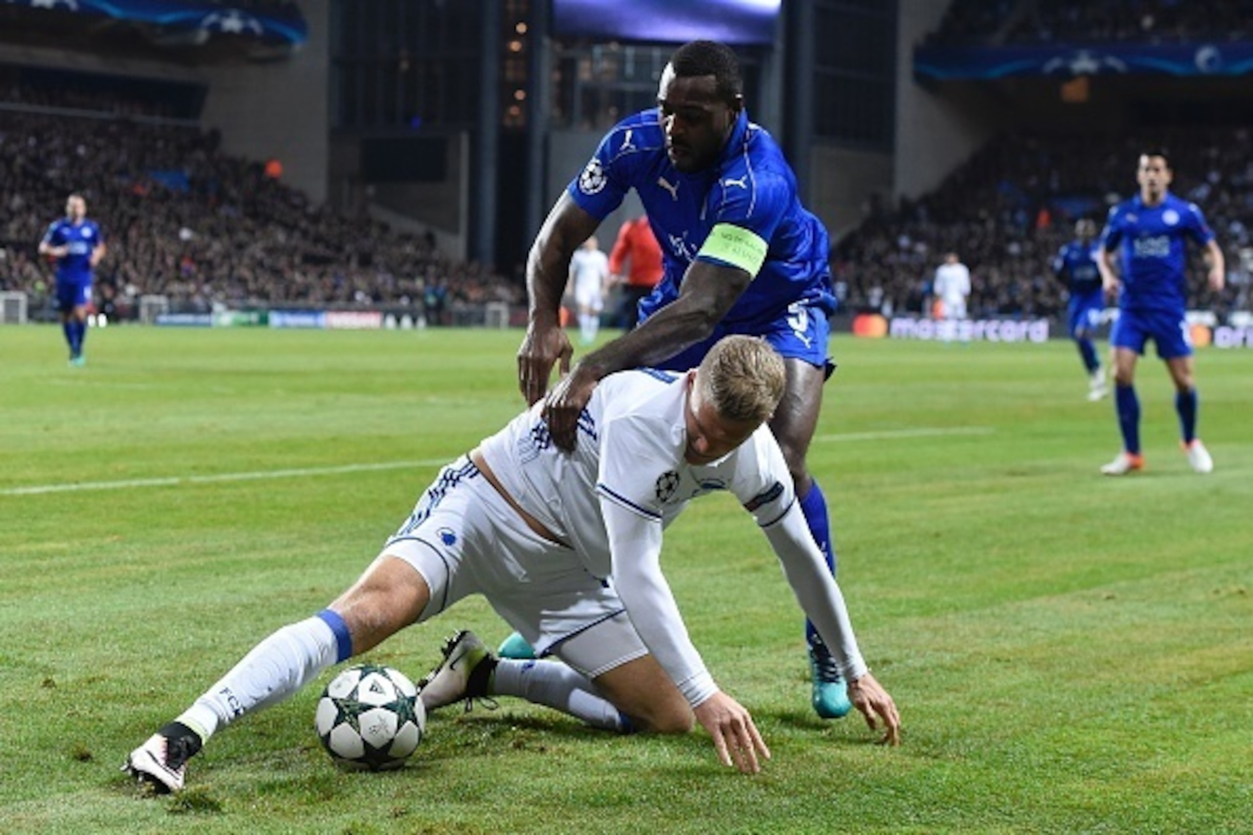 Leicester City's Jamaican defender Wes Morgan (top) vies with FC Copenhagen's Danish forward Andreas Cornelius during the UEFA Champions League group G football match between FC Copenhagen and Leicester City FC at the Telia Parken stadium in Copenhagen on Leicester City's Jamaican defender Wes Morgan (top) vies with FC Copenhagen's Danish forward Andreas Cornelius during the UEFA Champions League group G football match between FC Copenhagen and Leicester City FC at the Telia Parken stadium in Copenhagen on