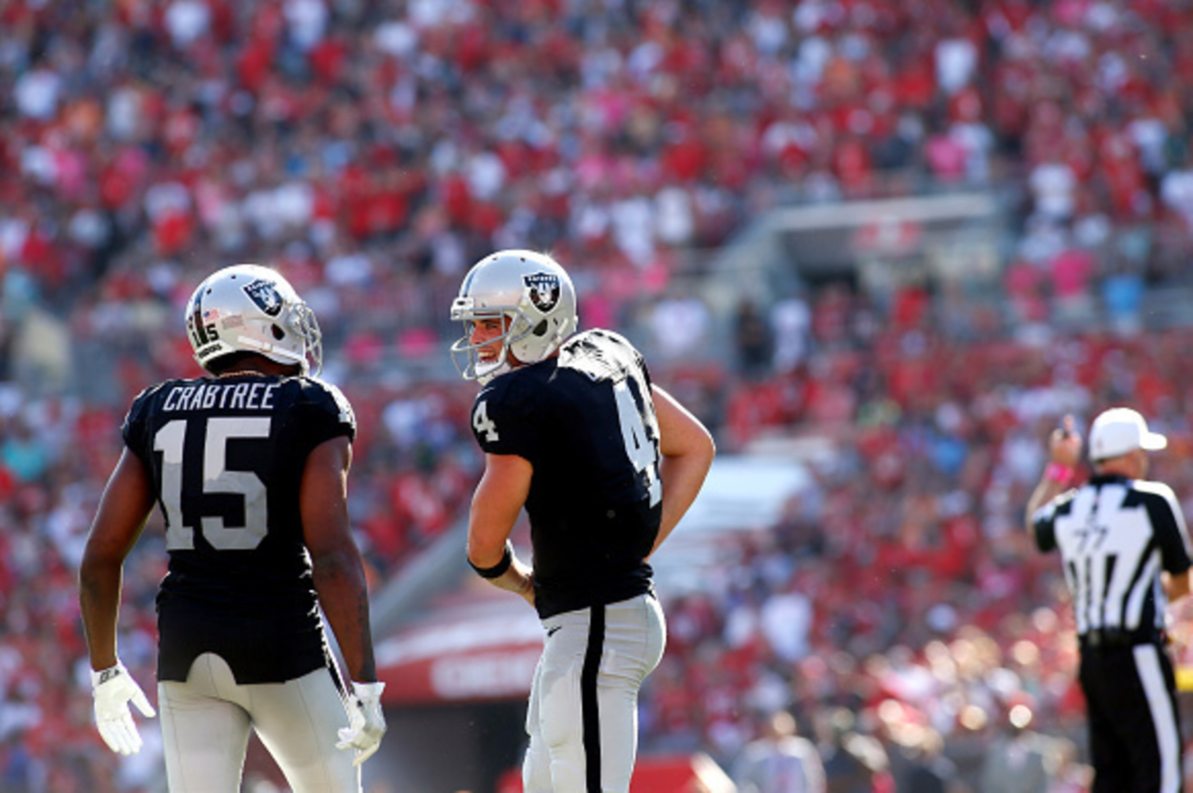 TAMPA, FL - OCTOBER 30: Quarterback Derek Carr #4 of the Oakland Raiders talks to wide receiver Michael Crabtree #15 on the field during the fourth quarter of an NFL game on October 30, 2016 at Raymond James Stadium in Tampa, Florida. (Photo by Brian Bla TAMPA, FL - OCTOBER 30: Quarterback Derek Carr #4 of the Oakland Raiders talks to wide receiver Michael Crabtree #15 on the field during the fourth quarter of an NFL game on October 30, 2016 at Raymond James Stadium in Tampa, Florida. (Photo by Brian Bla
