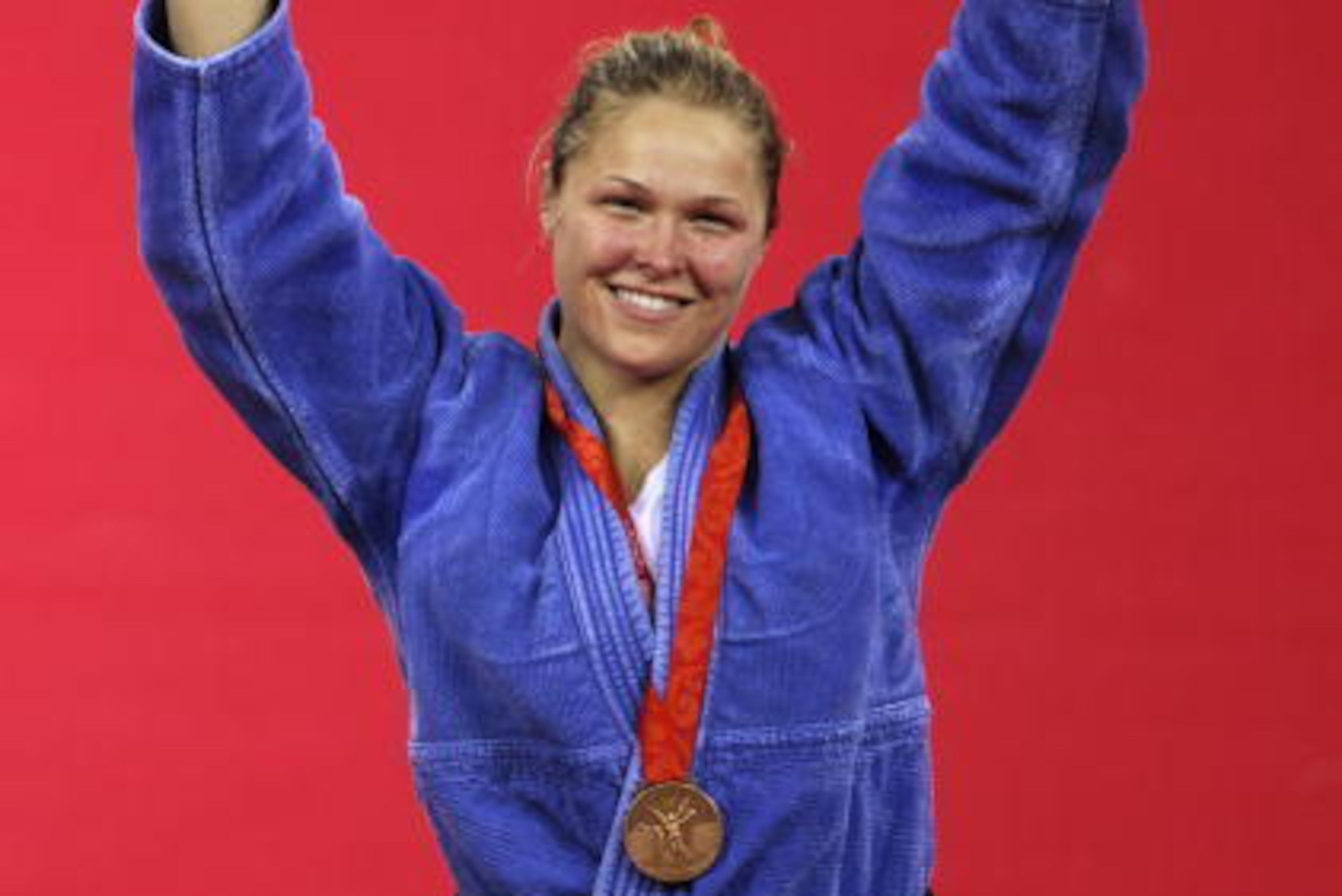 US Ronda Rousey poses with her bronze medal on the podium for the women's -70kg judo competition of the 2008 Beijing Olympic Games on August 13, 2008 in Beijing. Japan's Masae Ueno won the gold, Cuba's Anaysi Hernandez won the silver, US Ronda Rousey  and