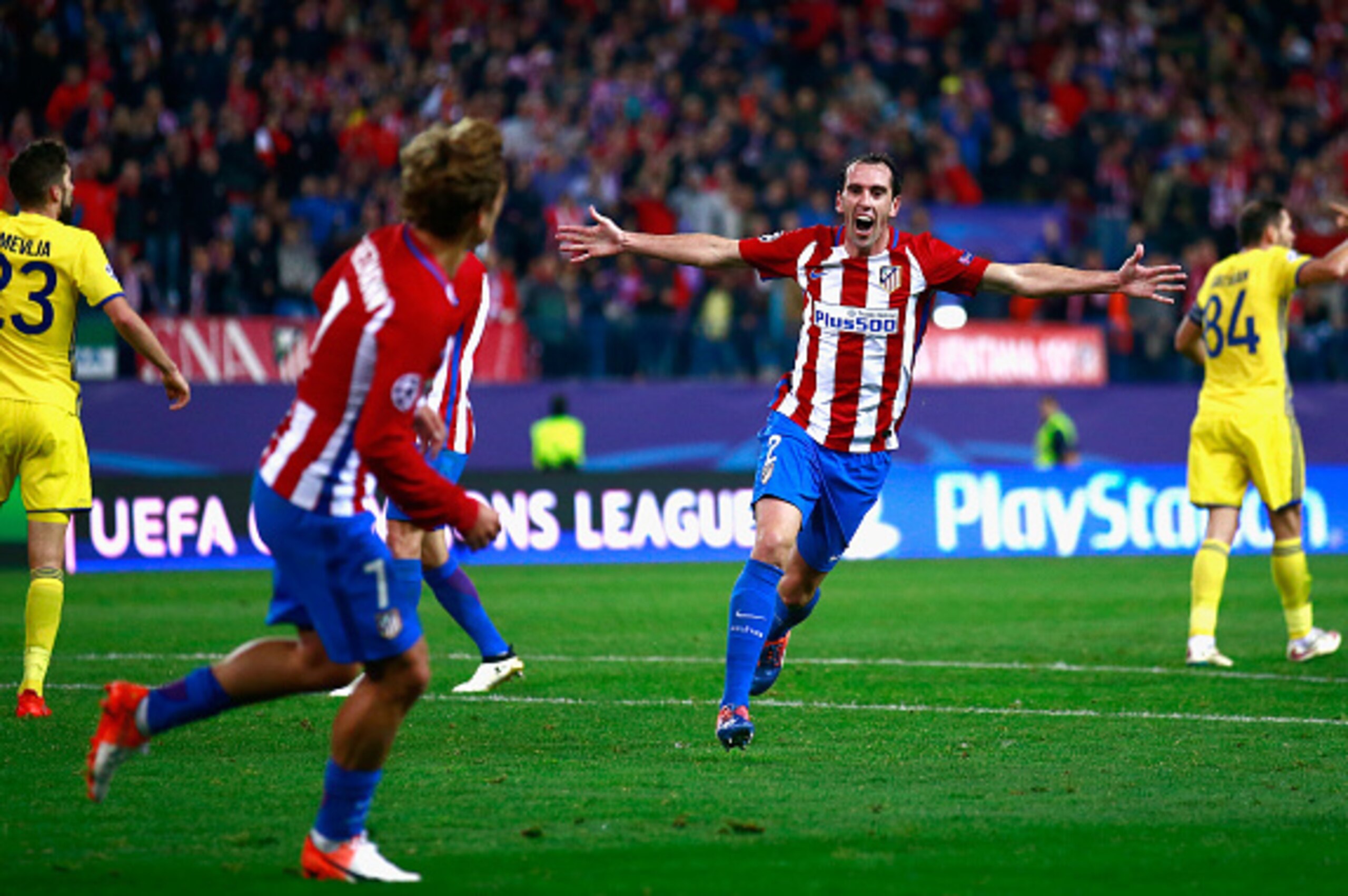 MADRID, SPAIN - NOVEMBER 01: Diego Godin of Atletico Madrid (C) celebrates his team mate Antoine Griezmann of Atletico Madrid (L) scoring their sides second goal during the UEFA Champions League Group D match between Club Atletico de Madrid and FC Rostov 