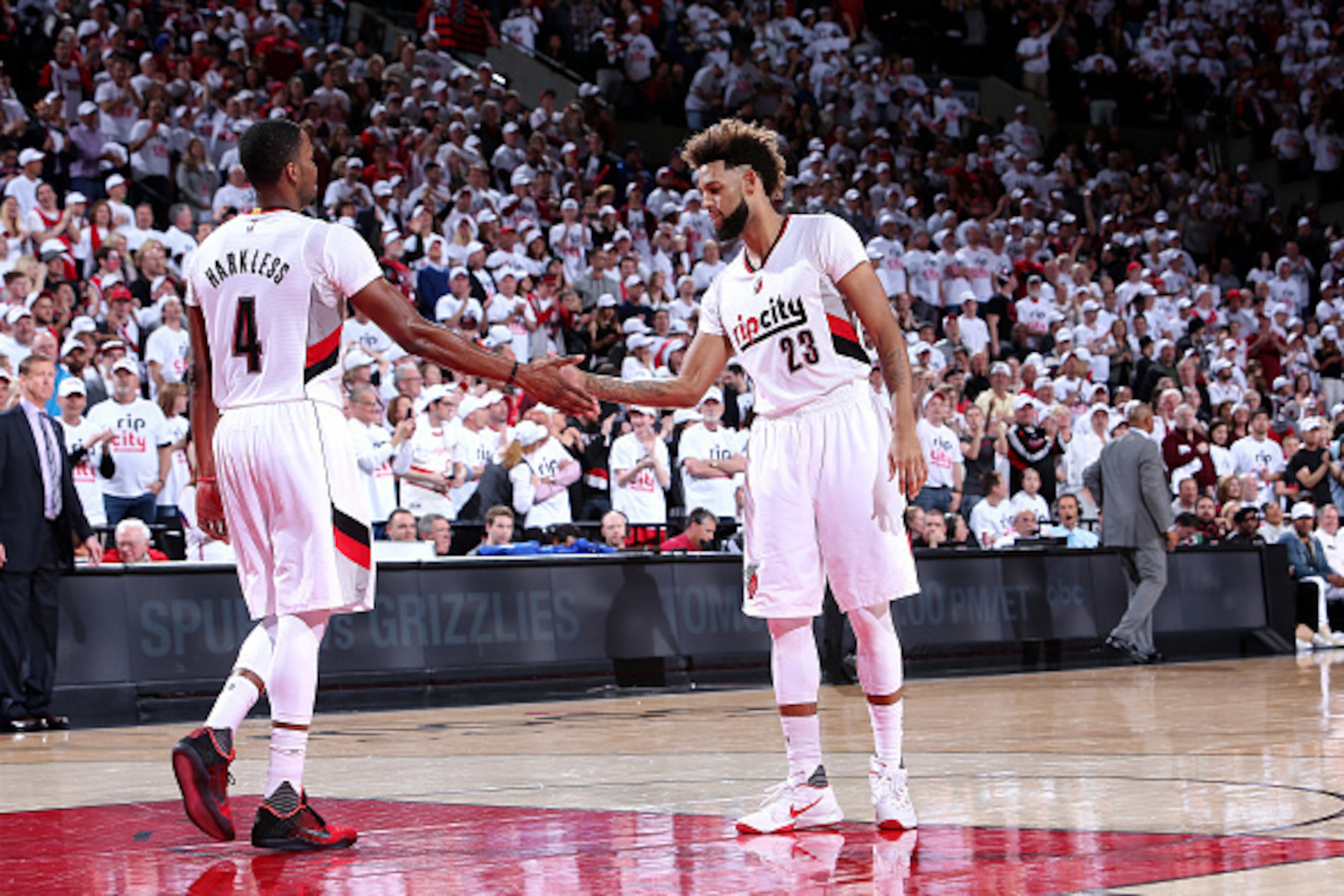 PORTLAND, OR - APRIL 23: Allen Crabbe #23 and Maurice Harkless #4 of the Portland Trail Blazers high five each other during the game against the Los Angeles Clippers in Game Three of the Western Conference Quarterfinals during the 2016 NBA Playoffs on Apr