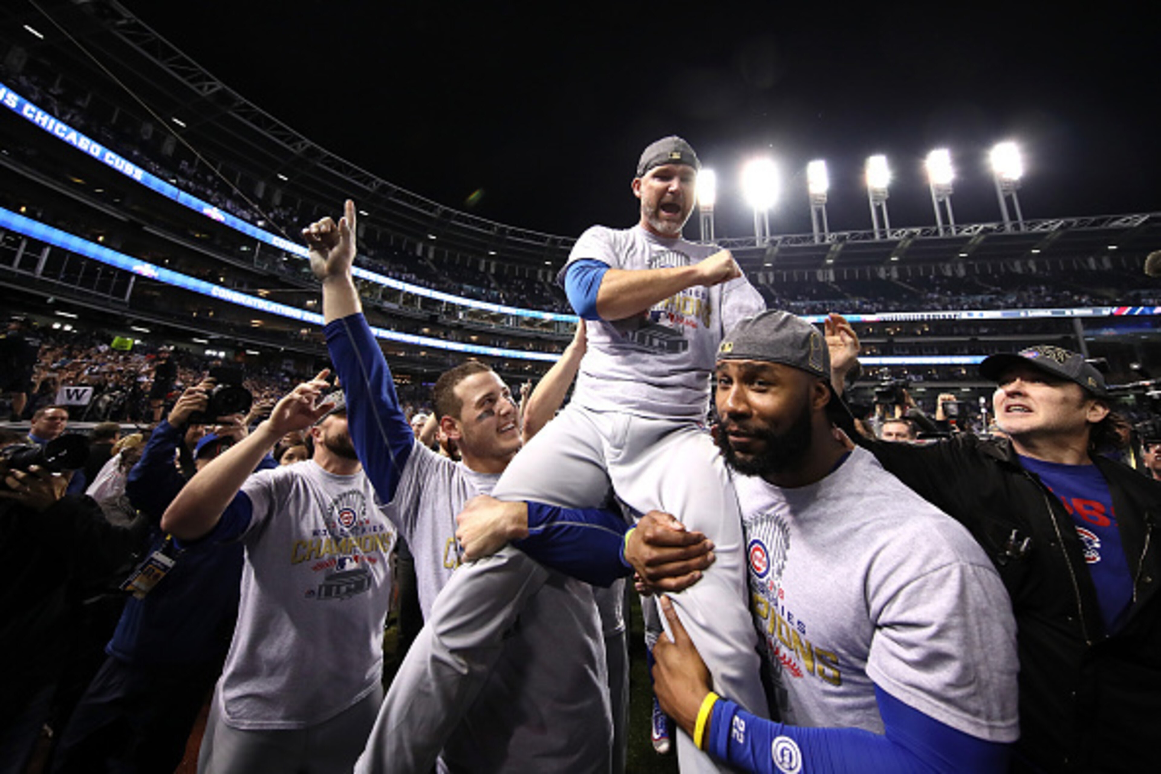 CLEVELAND, OH - NOVEMBER 02:  Anthony Rizzo #44, David Ross #3 and Jason Heyward #22 of the Chicago Cubs celebrate with actor John Cusack (R) after defeating the Cleveland Indians 8-7 in Game Seven of the 2016 World Series at Progressive Field on November