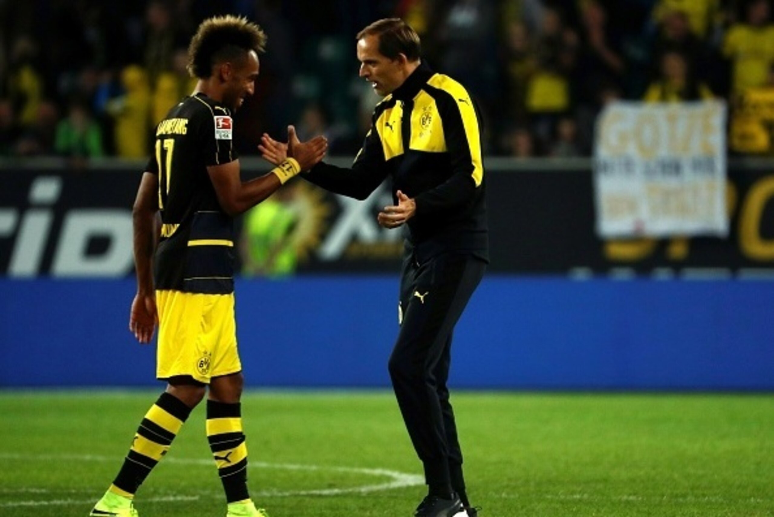 Dortmund's head coach Thomas Tuchel (R) and Dortmund's Gabonese forward Pierre-Emerick Aubameyang celebrate after the German first division Bundesliga football match between VfL Wolfsburg and Borussia Dortmund at Volkswagen Arena in Wolfsburg, central Ger