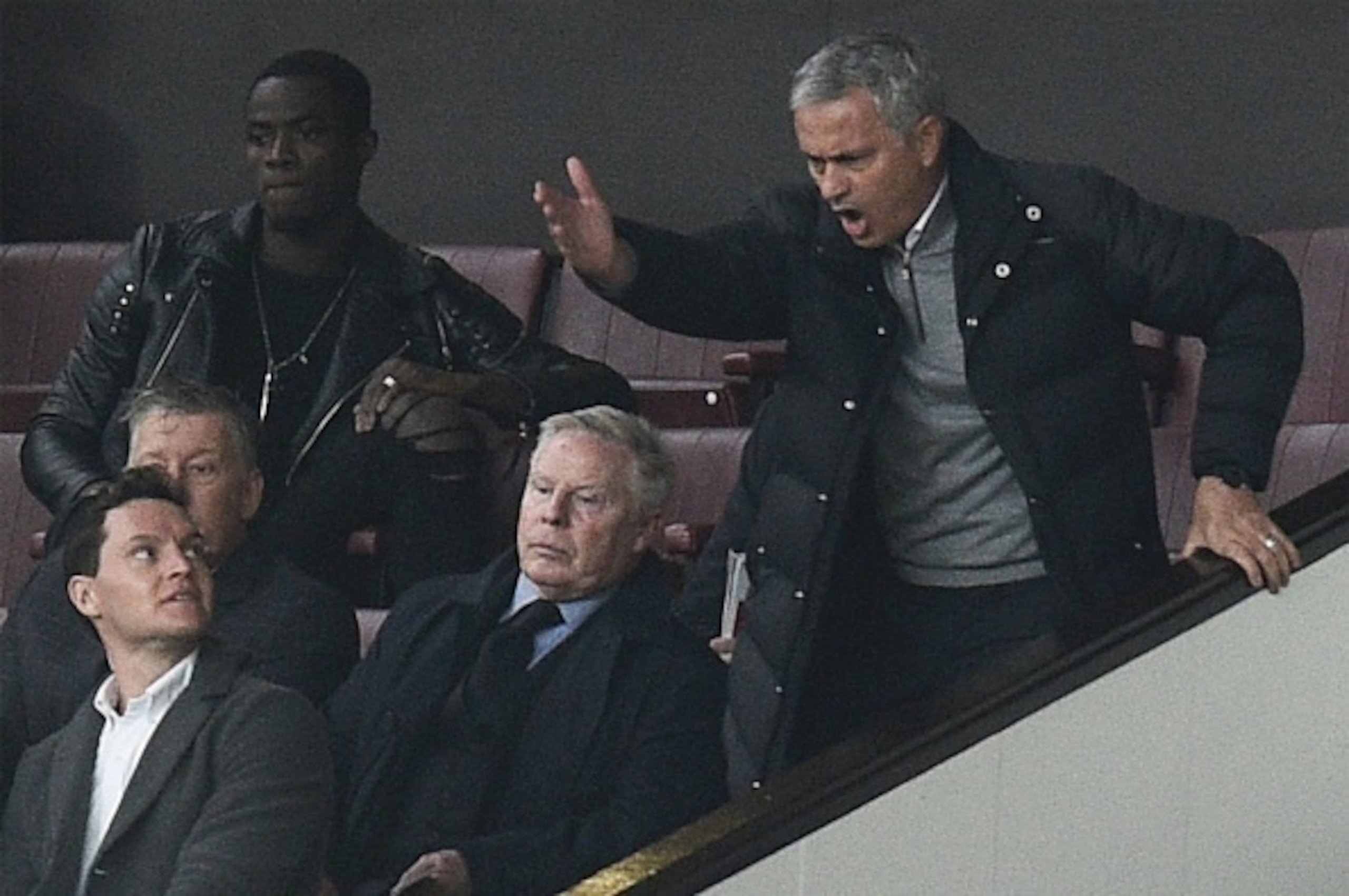 Manchester United's Portuguese manager Jose Mourinho (R) gestures and shouts in the Directors Box after being sent off to the stands during the English Premier League football match between Manchester United and Burnley at Old Trafford in Manchester, nort