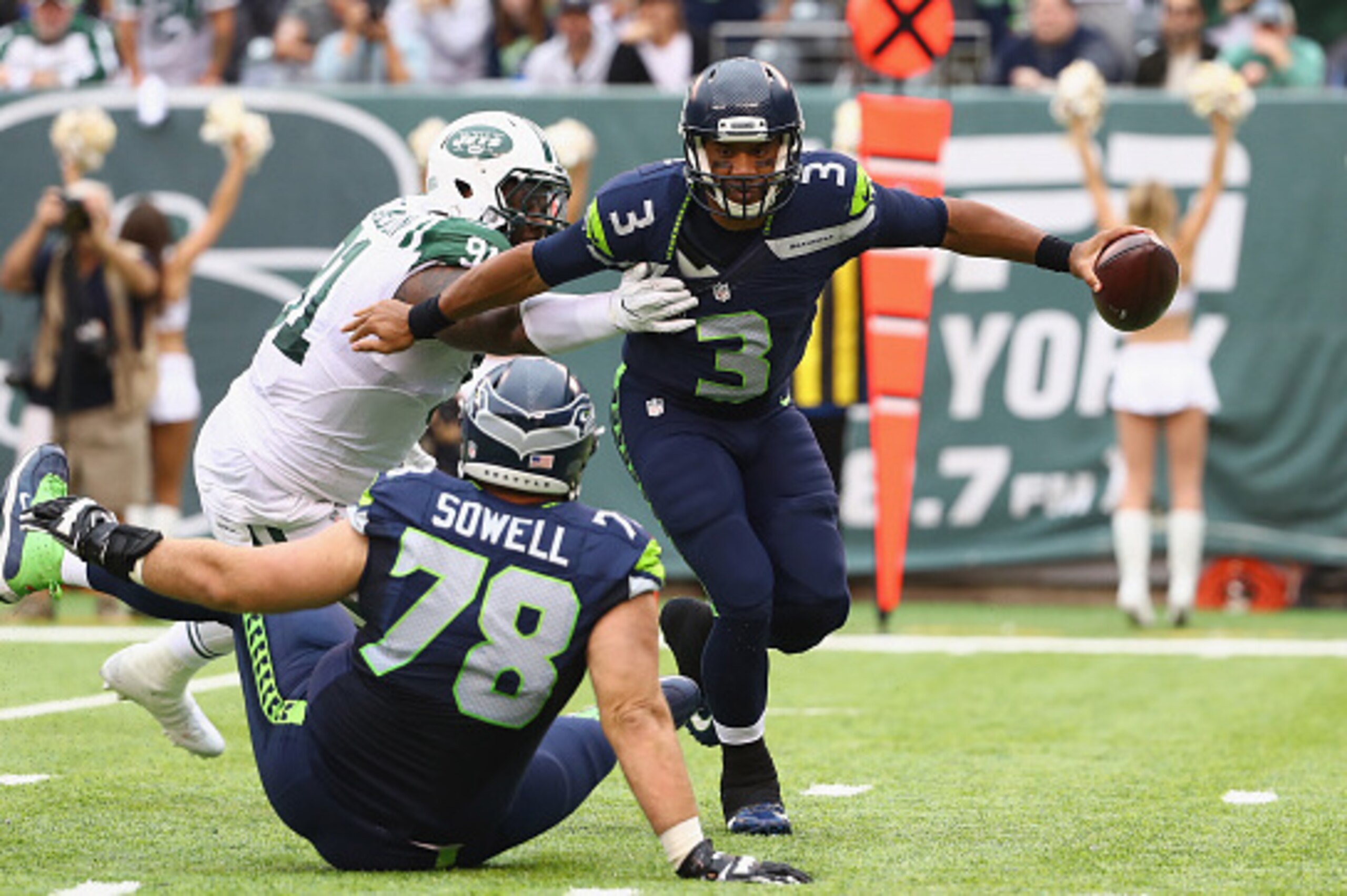 EAST RUTHERFORD, NJ - OCTOBER 02:  Quarterback Russell Wilson #3 of the Seattle Seahawks tries to avoid a tackle by Sheldon Richardson #91 of the New York Jets in the third quarter at MetLife Stadium on October 2, 2016 in East Rutherford, New Jersey.  (Ph