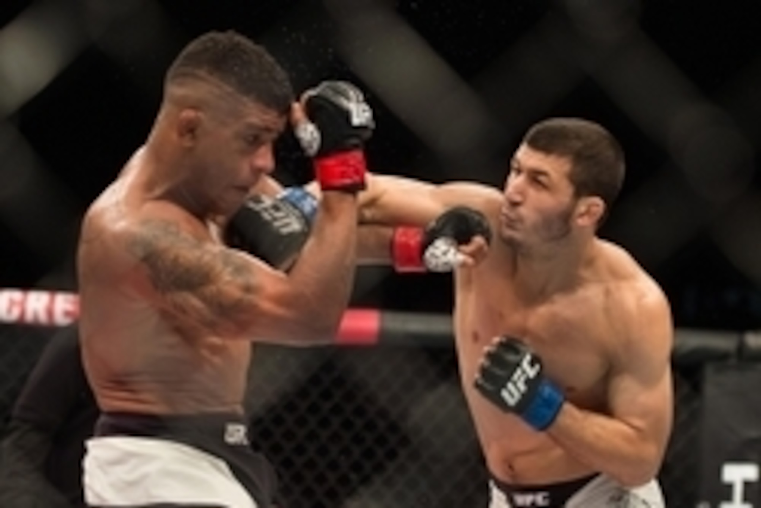 Nov 7, 2015; Sao Paulo, Brazil; Gilbert Burns(red gloves) fights Rashid Magomedov (blue gloves) during UFC Fight Night at Ibirapuera Gymnasium. Mandatory Credit: Jason Silva-USA TODAY Sports