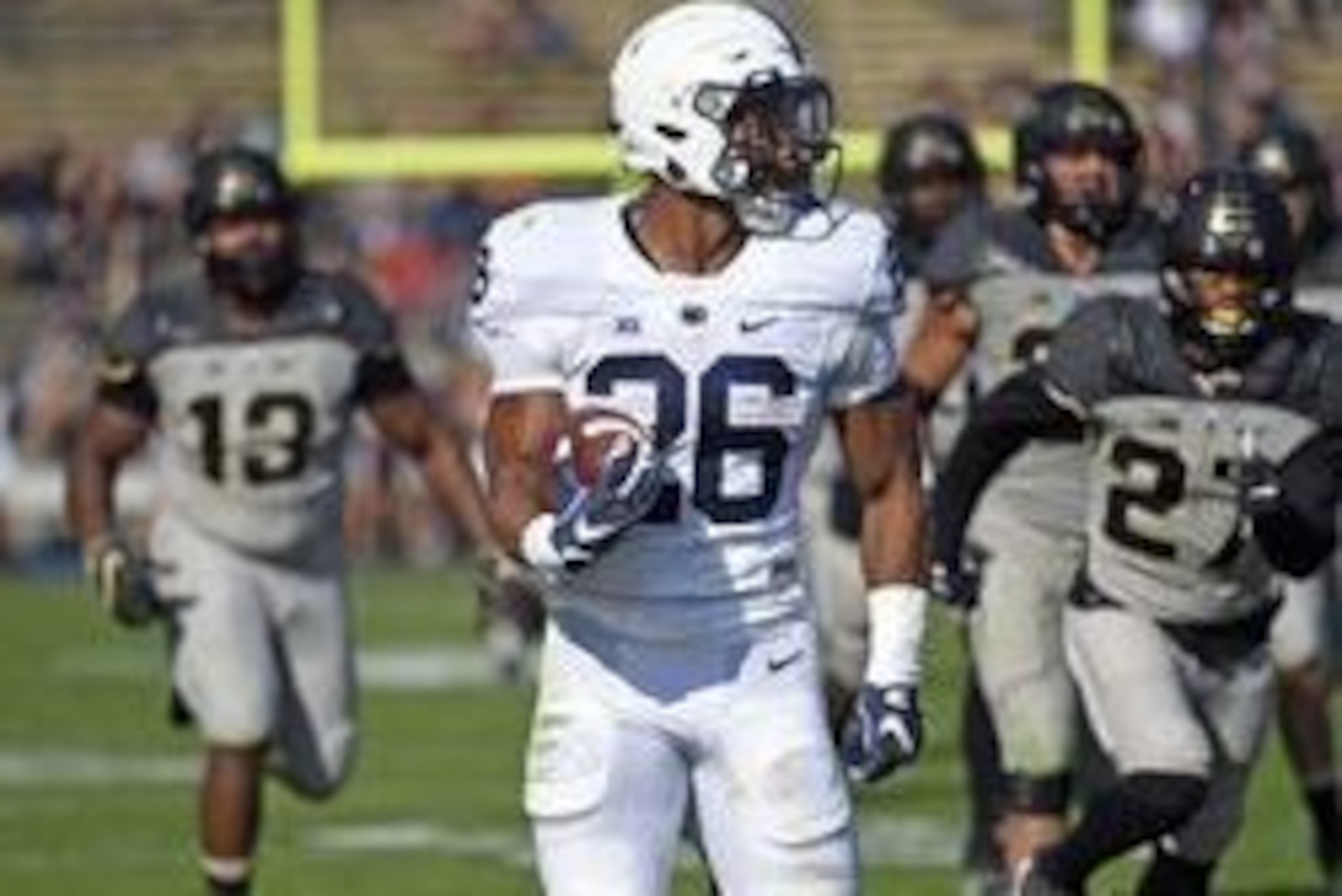 Oct 29, 2016; West Lafayette, IN, USA;  Penn State Nittany Lions running back Saquon Barkley (26) locks back as he runs past Purdue Boilermakers defensive end Gelen Robinson (13) and safety Navon Mosley (27) in the 2nd  half at Ross Ade Stadium. Penn Sate