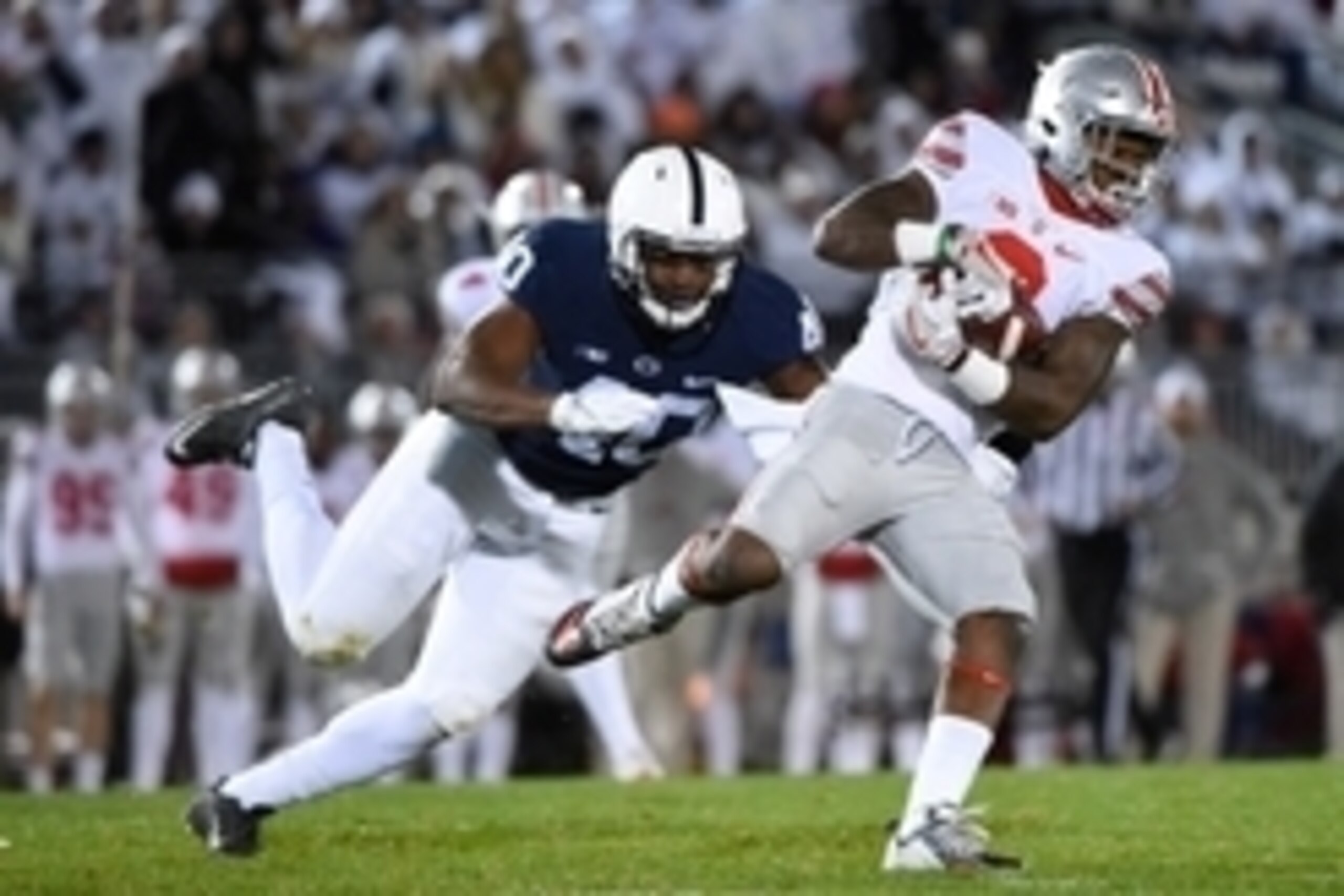 Oct 22, 2016; University Park, PA, USA; Ohio State Buckeyes wide receiver Dontre Wilson (2) runs with the ball after a catch as Penn State Nittany Lions linebacker Jason Cabinda (40) defends during the first quarter at Beaver Stadium. Mandatory Credit: Ri