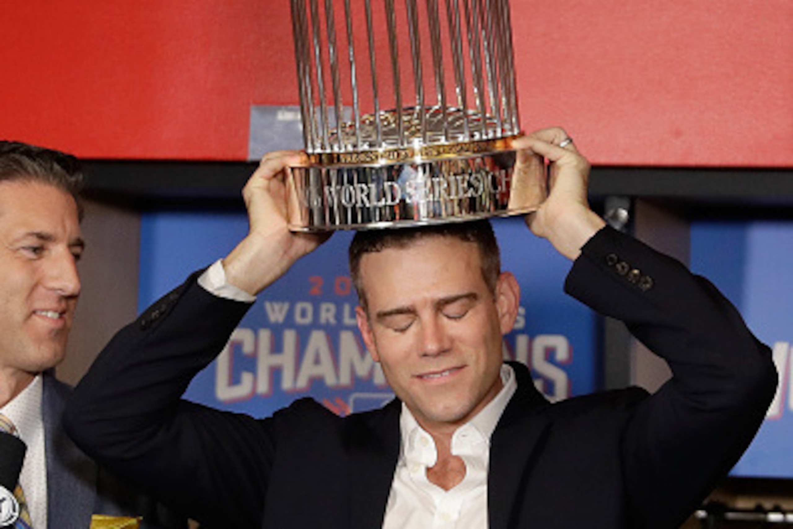CLEVELAND, OH - NOVEMBER 02:  President of Baseball Operations for the Chicago Cubs Theo Epstein reacts with The Commissioner's Trophy after the Chicago Cubs defeated the Cleveland Indians 8-7 in Game Seven of the 2016 World Series at Progressive Field on