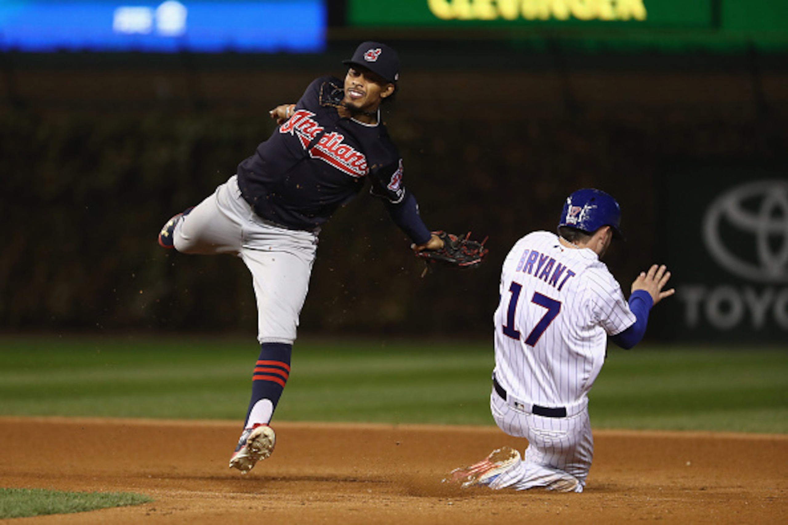 CHICAGO, IL - OCTOBER 30:  Kris Bryant #17 of the Chicago Cubs steals second base past Francisco Lindor #12 of the Cleveland Indians in the fifth inning in Game Five of the 2016 World Series at Wrigley Field on October 30, 2016 in Chicago, Illinois.  (Pho