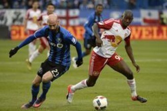 Oct 30, 2016; Montreal , Quebec, Canada; Montreal Impact defender Laurent Ciman (23) and New York Red Bulls forward Bradley Wright-Phillips (99) battle for the ball during the second half at Stade Saputo. Mandatory Credit: Eric Bolte-USA TODAY Sports