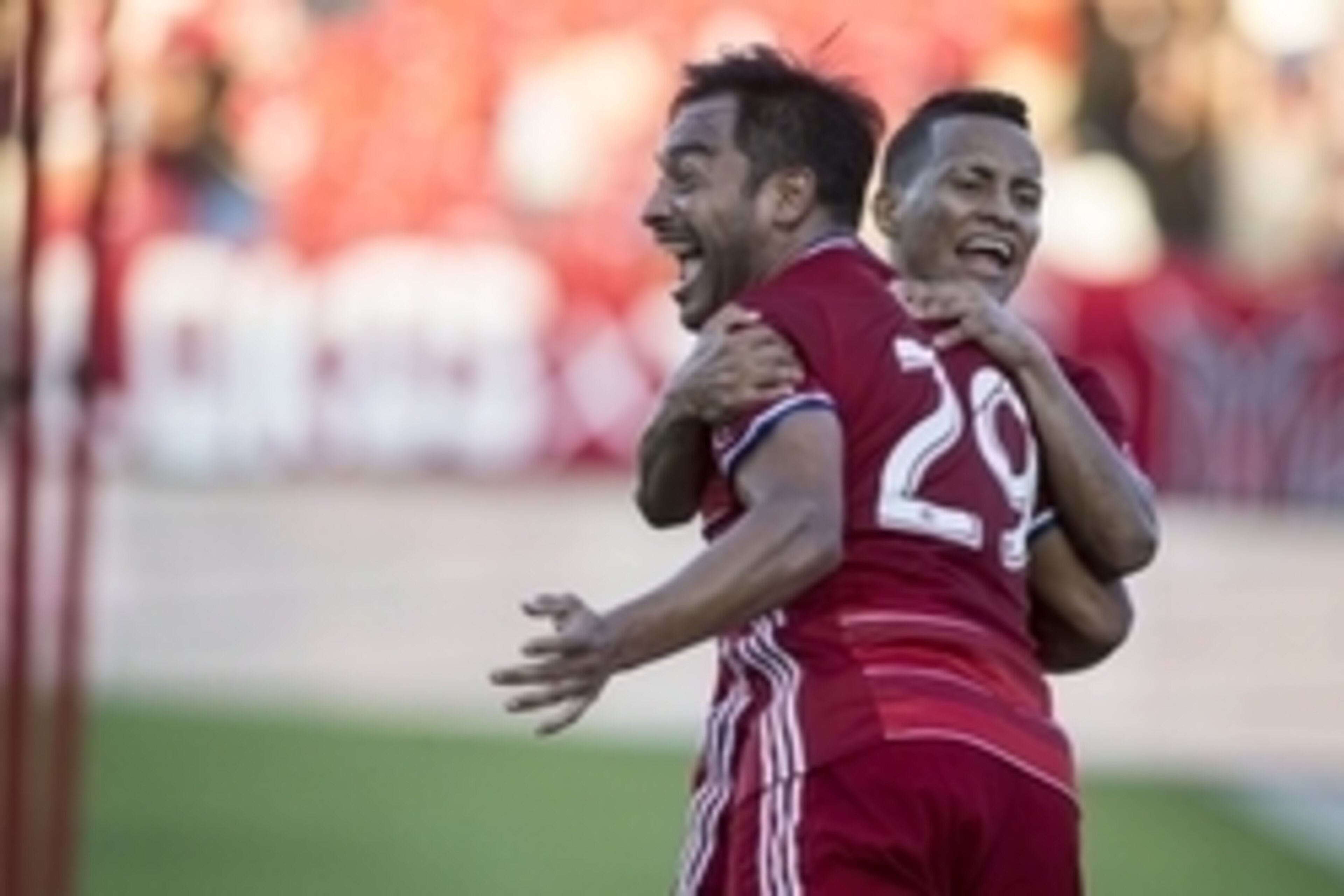 Oct 16, 2016; Dallas, TX, USA; FC Dallas forward Carlos Ruiz (29) and midfielder Michael Barrios (21) celebrate scoring a goal in the second half against the Seattle Sounders at Toyota Stadium. FC Dallas won 2-1. Mandatory Credit: Tim Heitman-USA TODAY Sp