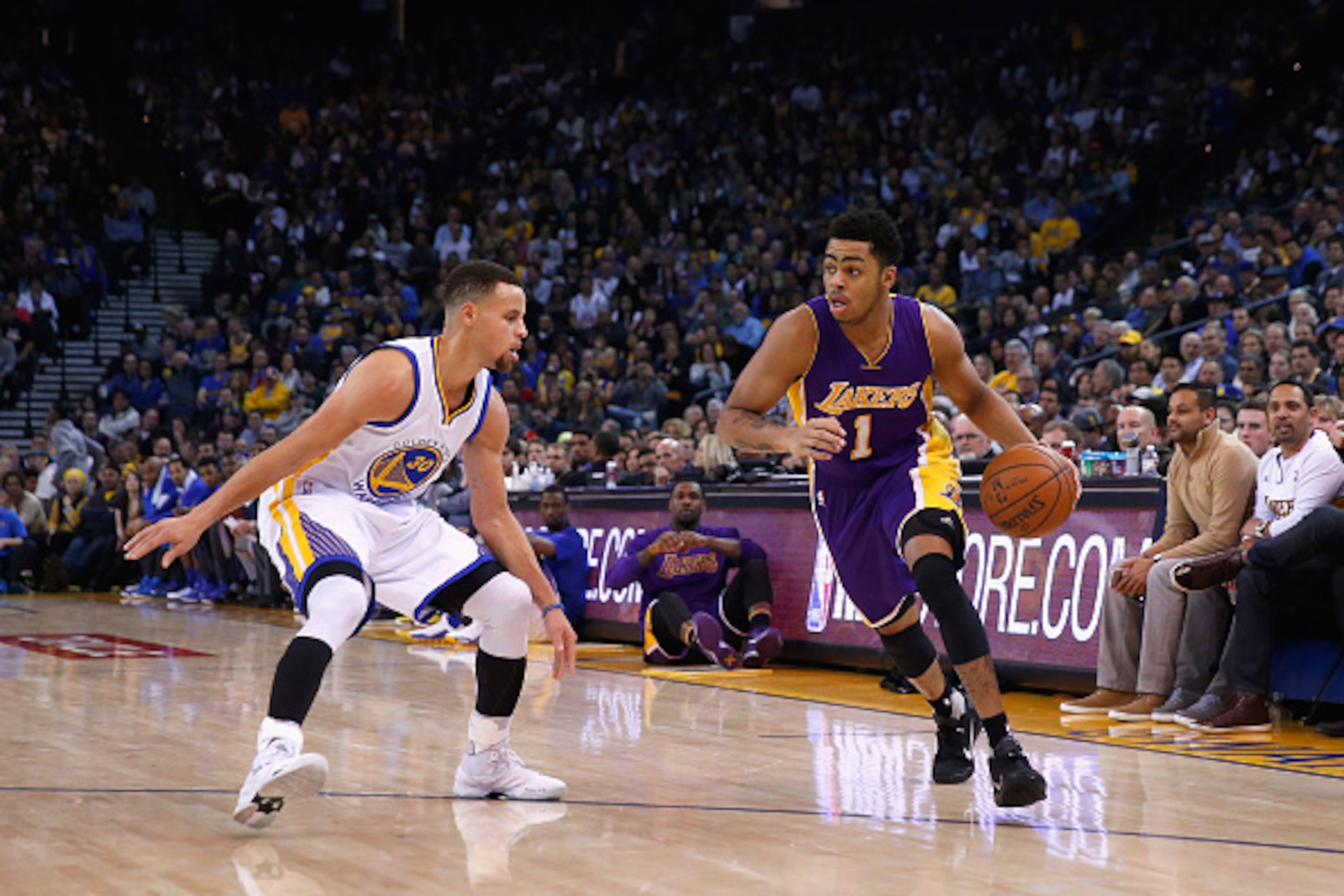 OAKLAND, CA - JANUARY 14:  D'Angelo Russell #1 of the Los Angeles Lakers is covered by Stephen Curry #30 of the Golden State Warriors at ORACLE Arena on January 14, 2016 in Oakland, California. NOTE TO USER: User expressly acknowledges and agrees that, by