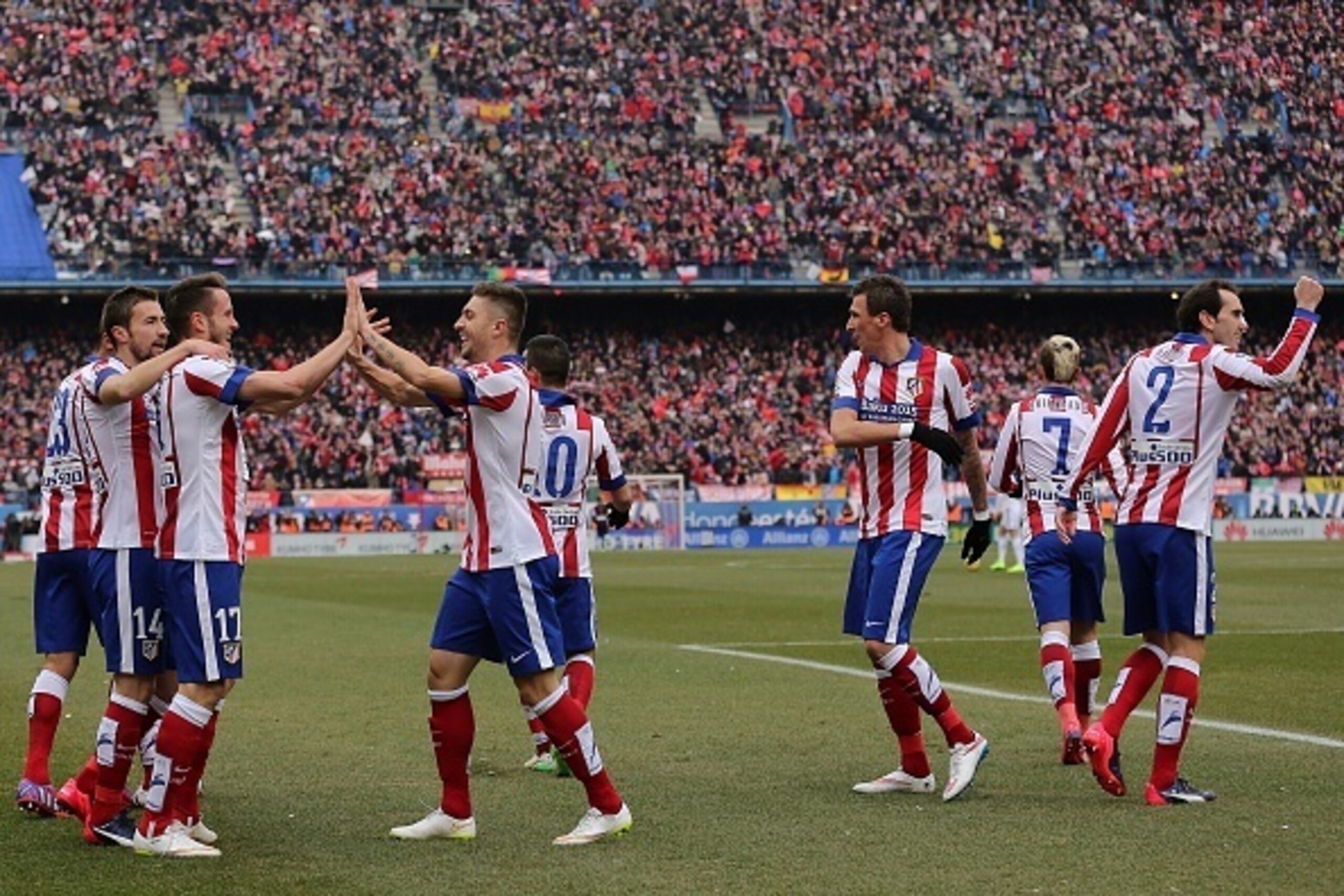 Atletico Madrid's midfielder Saul Niguez (2ndL) celebrates with teammates fater scoring their second goal during the Spanish league football match Club Atletico de Madrid vs Real Madrid CF at the Vicente Calderon stadium in Madrid on February 7, 2015. A Atletico Madrid's midfielder Saul Niguez (2ndL) celebrates with teammates fater scoring their second goal during the Spanish league football match Club Atletico de Madrid vs Real Madrid CF at the Vicente Calderon stadium in Madrid on February 7, 2015. A