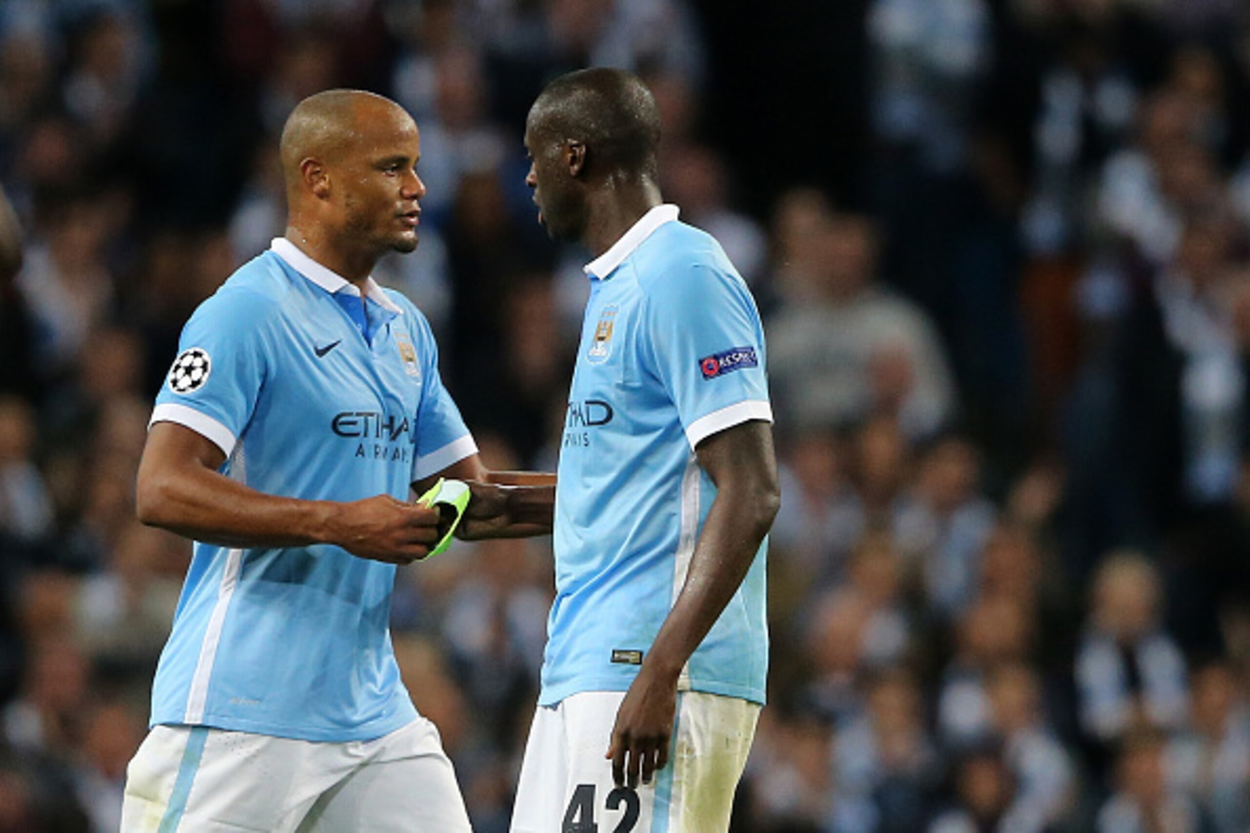 MANCHESTER, ENGLAND - SEPTEMBER 15:  Vincent Kompany hands the captains arm band to Yaya Toure of Manchester City during the UEFA Champions League Group D match between Manchester City FC and Juventus at the Etihad Stadium on September 15, 2015 in Manches