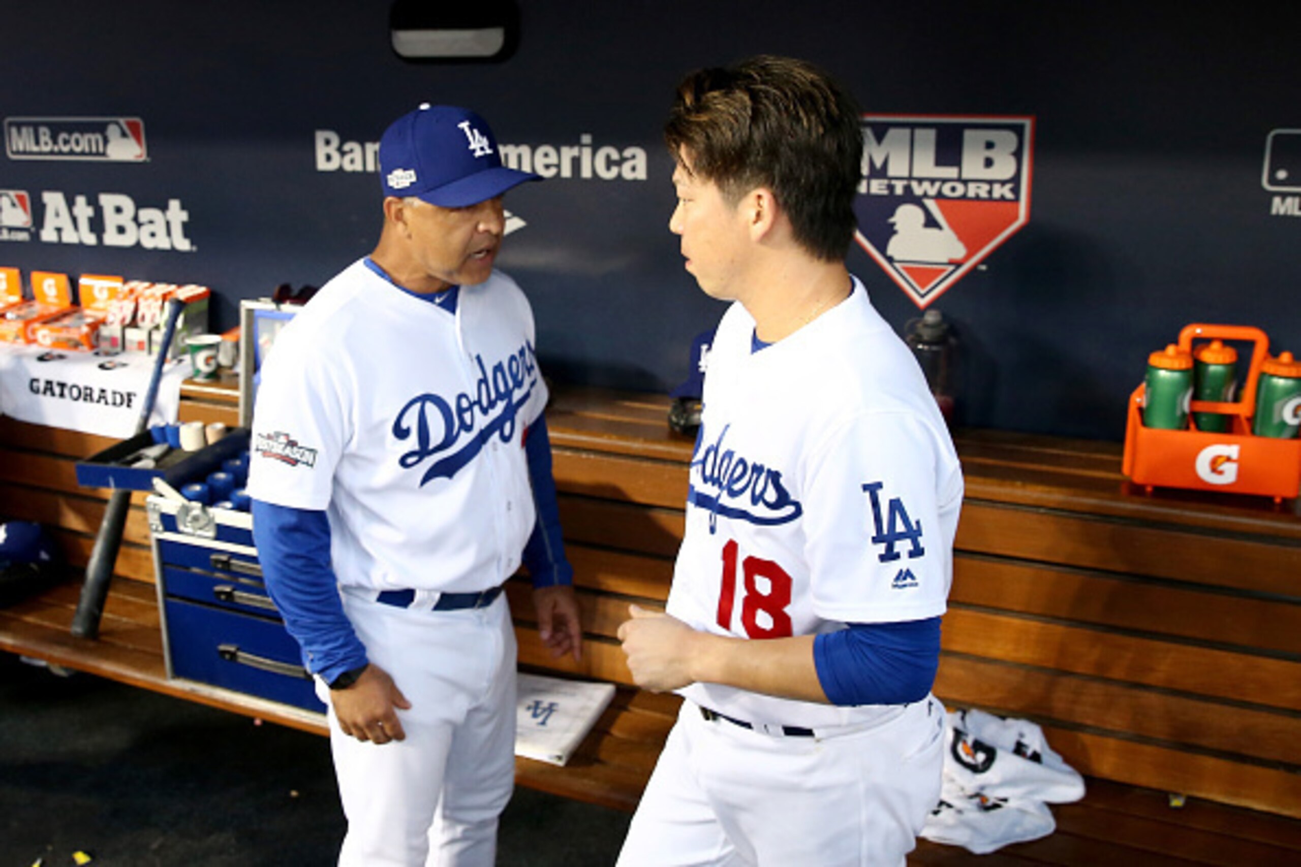 LOS ANGELES, CA - OCTOBER 20:  Kenta Maeda #18 of the Los Angeles Dodgers talks with manager Dave Roberts #30 in the dugout against the Chicago Cubs in game five of the National League Division Series at Dodger Stadium on October 20, 2016 in Los Angeles, 
