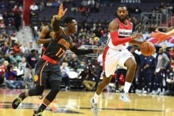 Nov 4, 2016; Washington, DC, USA; Washington Wizards guard John Wall (2) brings the ball up court as Atlanta Hawks guard Dennis Schroder (17) looks on during the first half at Verizon Center. Mandatory Credit: Brad Mills-USA TODAY Sports