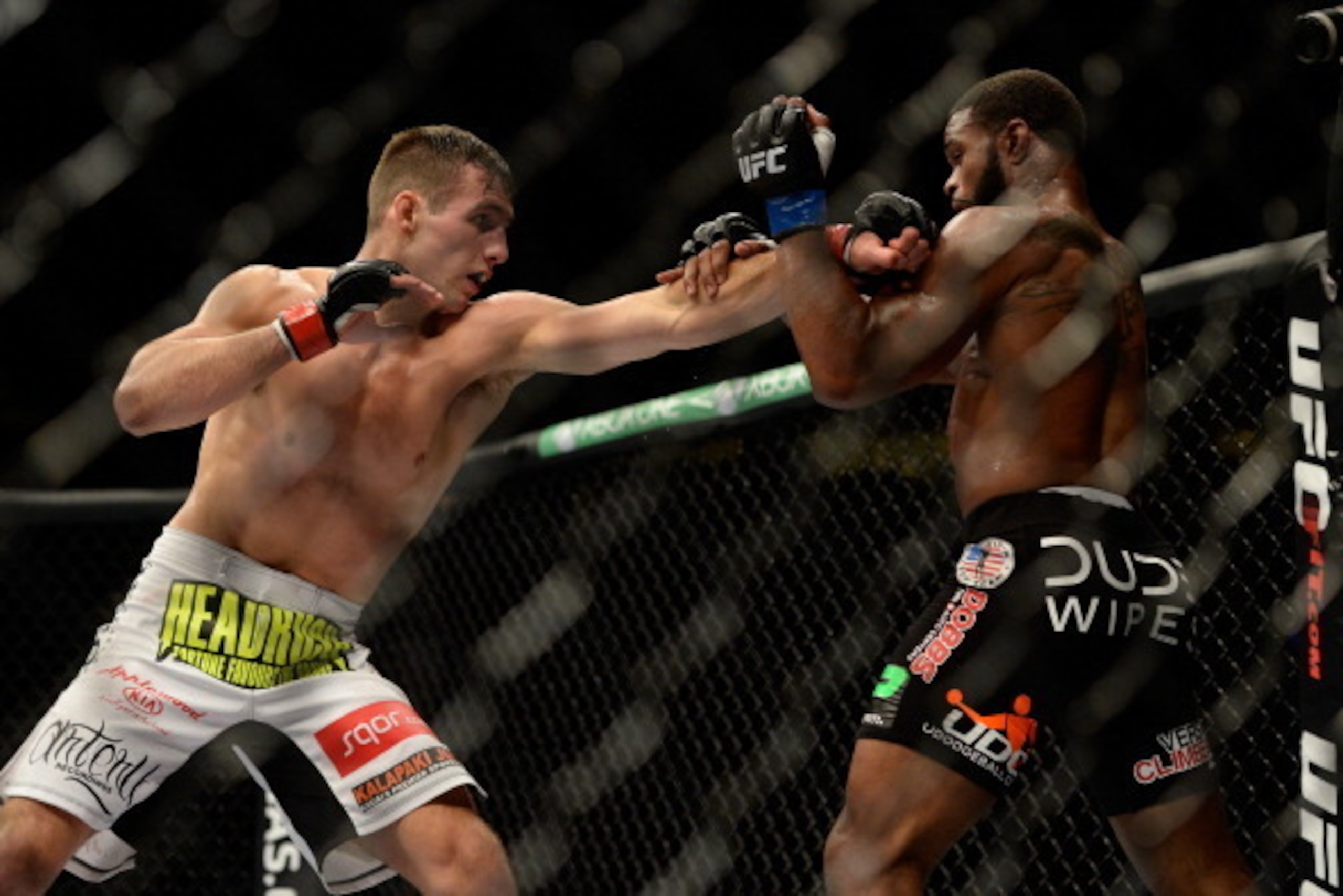 VANCOUVER, BC - JUNE 14:  (L-R) Rory MacDonald punches Tyron Woodley during the UFC 174 event at Rogers Arena on June 14, 2014 in Vancouver, British Columbia, Canada. (Photo by Jeff Bottari/Zuffa LLC/Zuffa LLC via Getty Images)