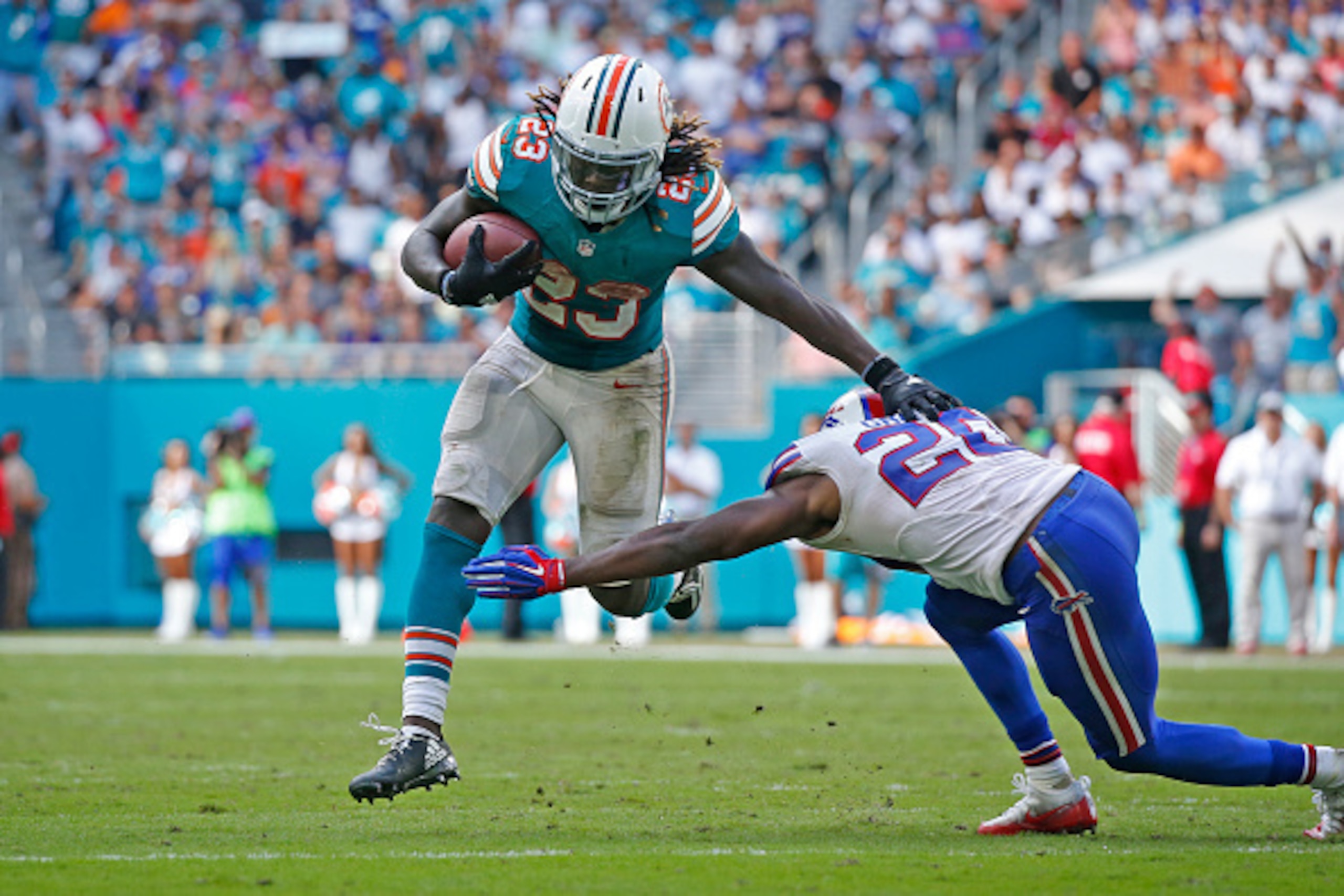 MIAMI GARDENS, FL - OCTOBER 23: Corey Graham #20 of the Buffalo Bills defends against Jay Ajayi #23 of the Miami Dolphins as eh runs with the ball on October 23, 2016 at Hard Rock Stadium in Miami Gardens, Florida. Miami defeated Buffalo 28-25. (Photo by 
