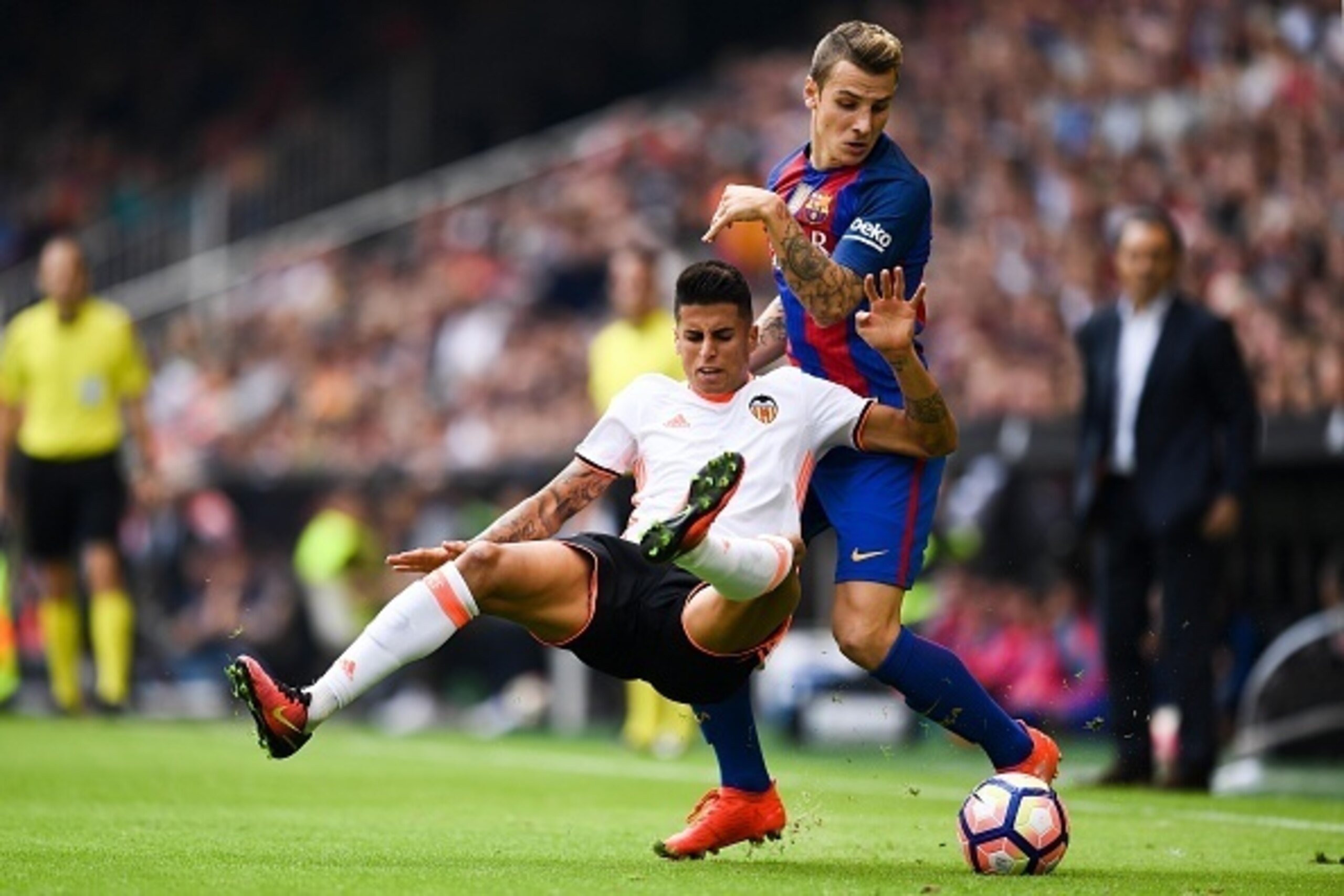 VALENCIA, SPAIN - OCTOBER 22:  Joao Cancelo of Valencia CF is brought down by Lucas Digne of FC Barcelona during the La Liga match between Valencia CF and FC Barcelona at Mestalla stadium on October 22, 2016 in Valencia, Spain.  (Photo by David Ramos/Gett
