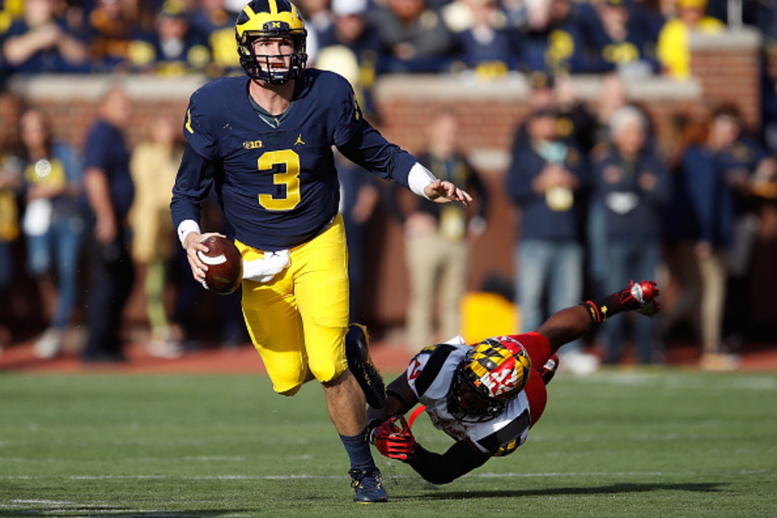 ANN ARBOR, MI - NOVEMBER 05: Wilton Speight #3 of the Michigan Wolverines escapes the tackle of Jarrett Ross #32 of the Maryland Terrapins during the first half on November 5, 2016 at Michigan Stadium in Ann Arbor, Michigan. (Photo by Gregory Shamus/Getty ANN ARBOR, MI - NOVEMBER 05: Wilton Speight #3 of the Michigan Wolverines escapes the tackle of Jarrett Ross #32 of the Maryland Terrapins during the first half on November 5, 2016 at Michigan Stadium in Ann Arbor, Michigan. (Photo by Gregory Shamus/Getty