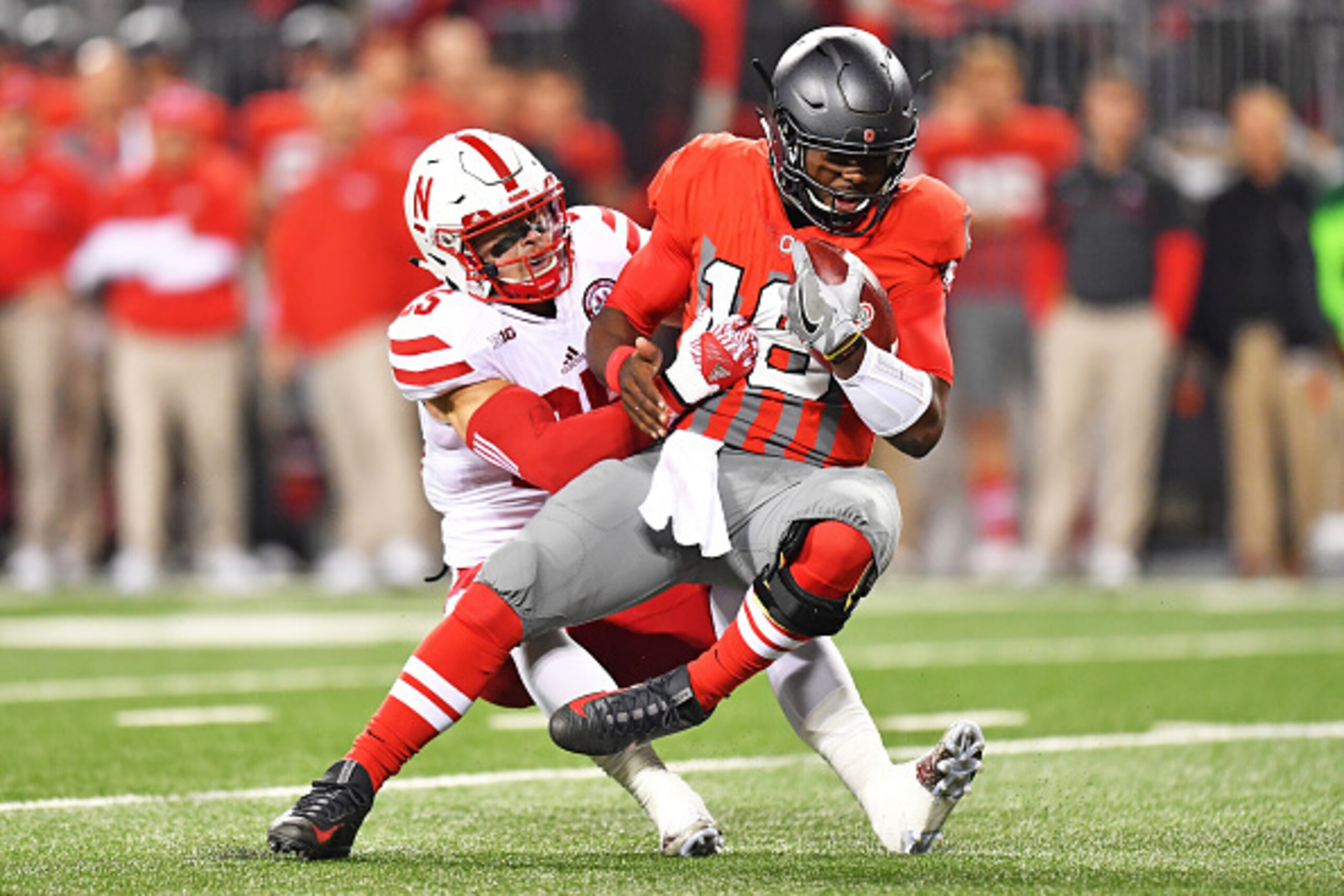 COLUMBUS, OH - NOVEMBER 5:  Nathan Gerry #25 of the Nebraska Cornhuskers drags down J.T. Barrett #16 of the Ohio State Buckeyes after a short gain in the first quarter at Ohio Stadium on November 5, 2016 in Columbus, Ohio.  (Photo by Jamie Sabau/Getty Ima