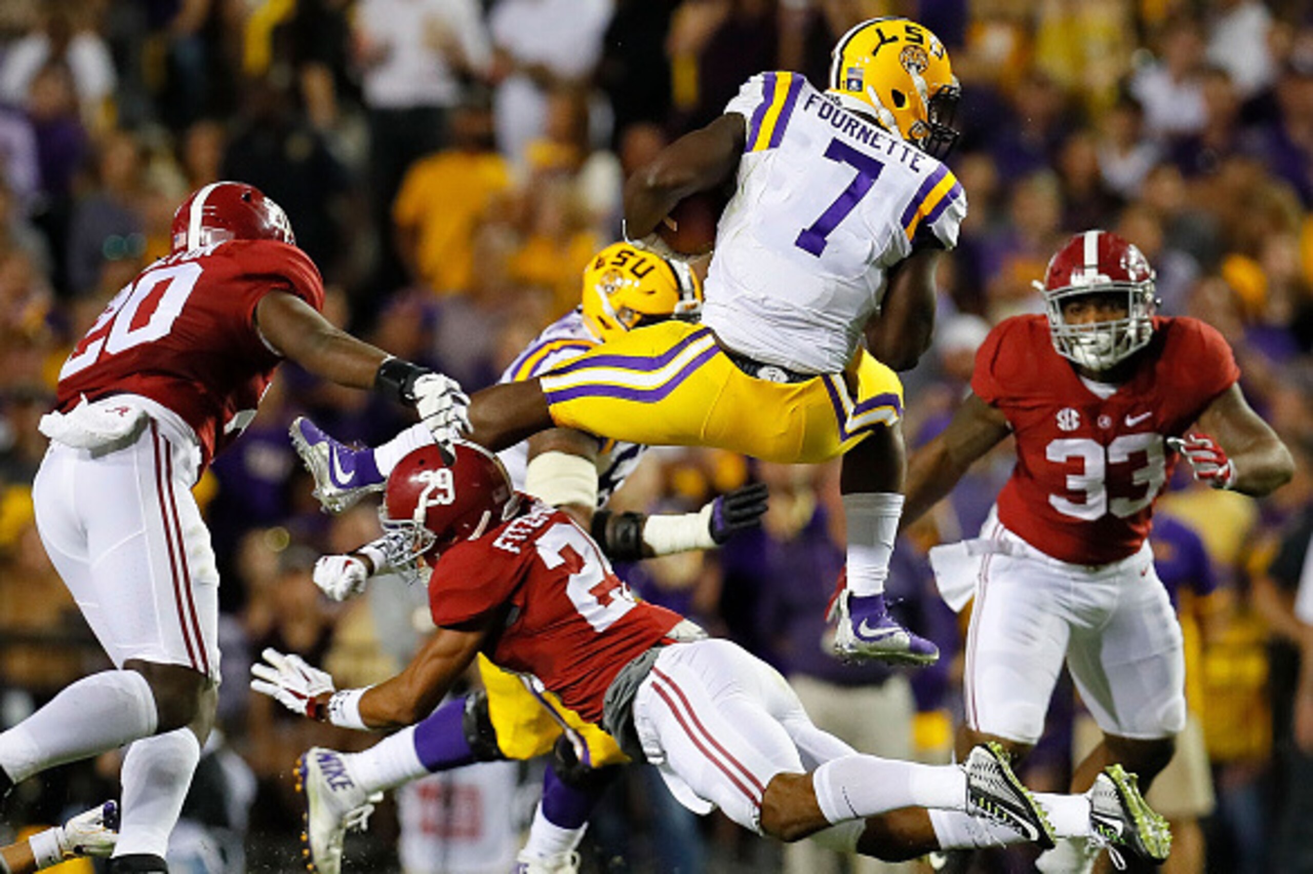BATON ROUGE, LA - NOVEMBER 05:  Leonard Fournette #7 of the LSU Tigers leaps over Minkah Fitzpatrick #29 of the Alabama Crimson Tide at Tiger Stadium on November 5, 2016 in Baton Rouge, Louisiana.  (Photo by Kevin C. Cox/Getty Images)