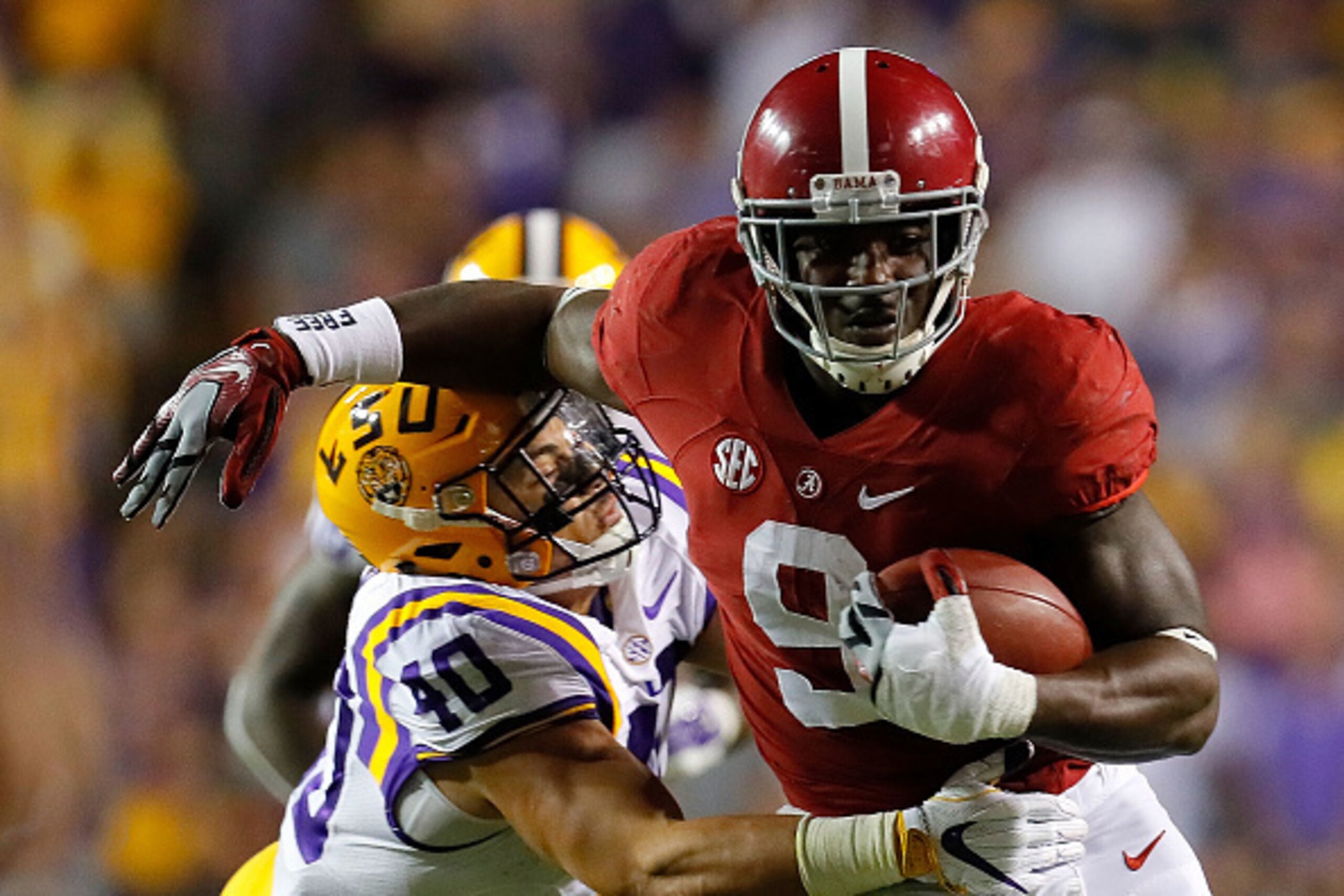 BATON ROUGE, LA - NOVEMBER 05:  Bo Scarbrough #9 of the Alabama Crimson Tide attempts to break a tackle by Duke Riley #40 of the LSU Tigers at Tiger Stadium on November 5, 2016 in Baton Rouge, Louisiana.  (Photo by Kevin C. Cox/Getty Images)