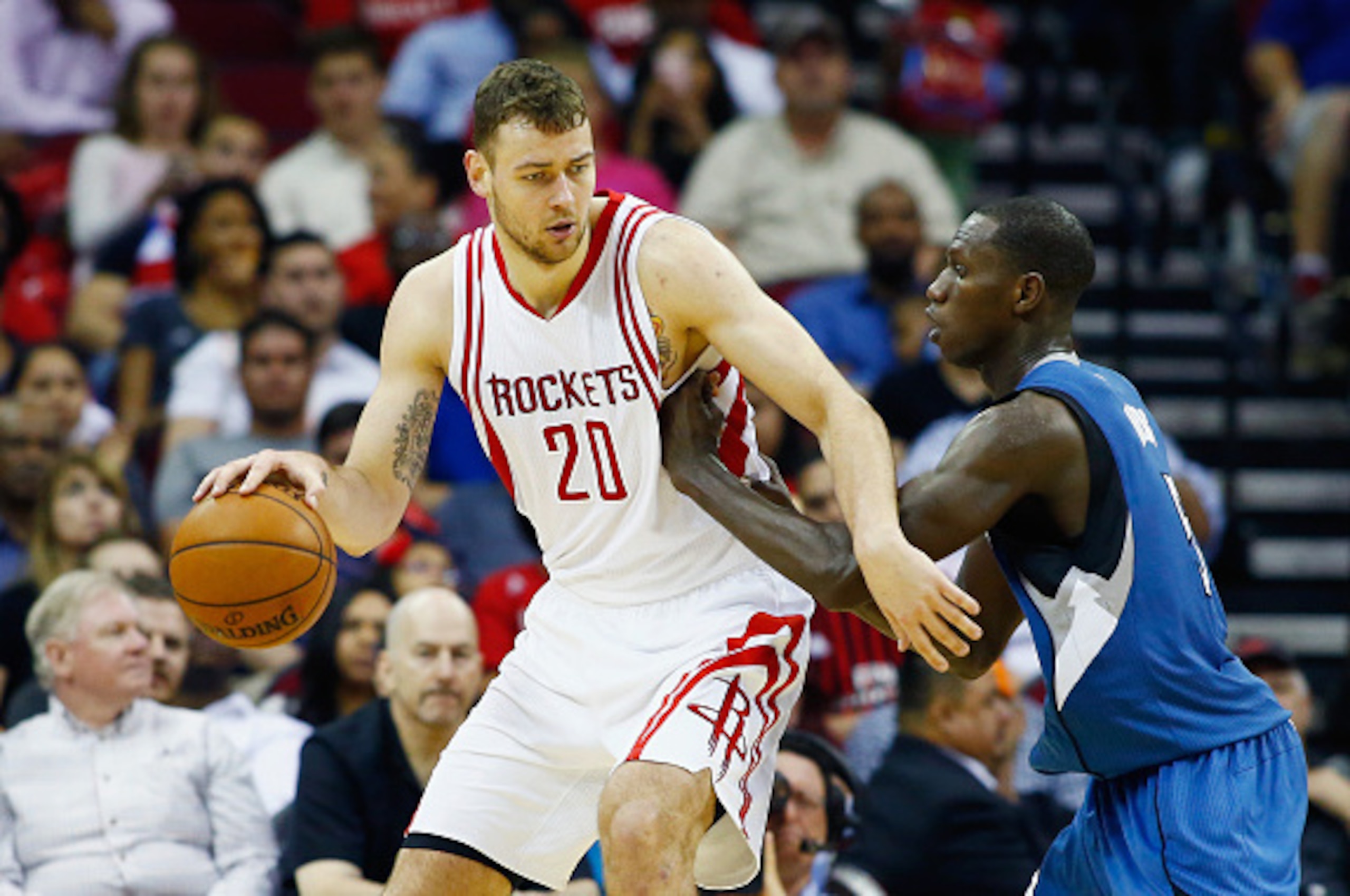 HOUSTON, TX - MARCH 18:  Donatas Motiejunas #20 of the Houston Rockets drives with the basketball against Gorgui Dieng #5 of the Minnesota Timberwolves during their game at the Toyota Center on March 18, 2016 in Houston, Texas.  NOTE TO USER: User express