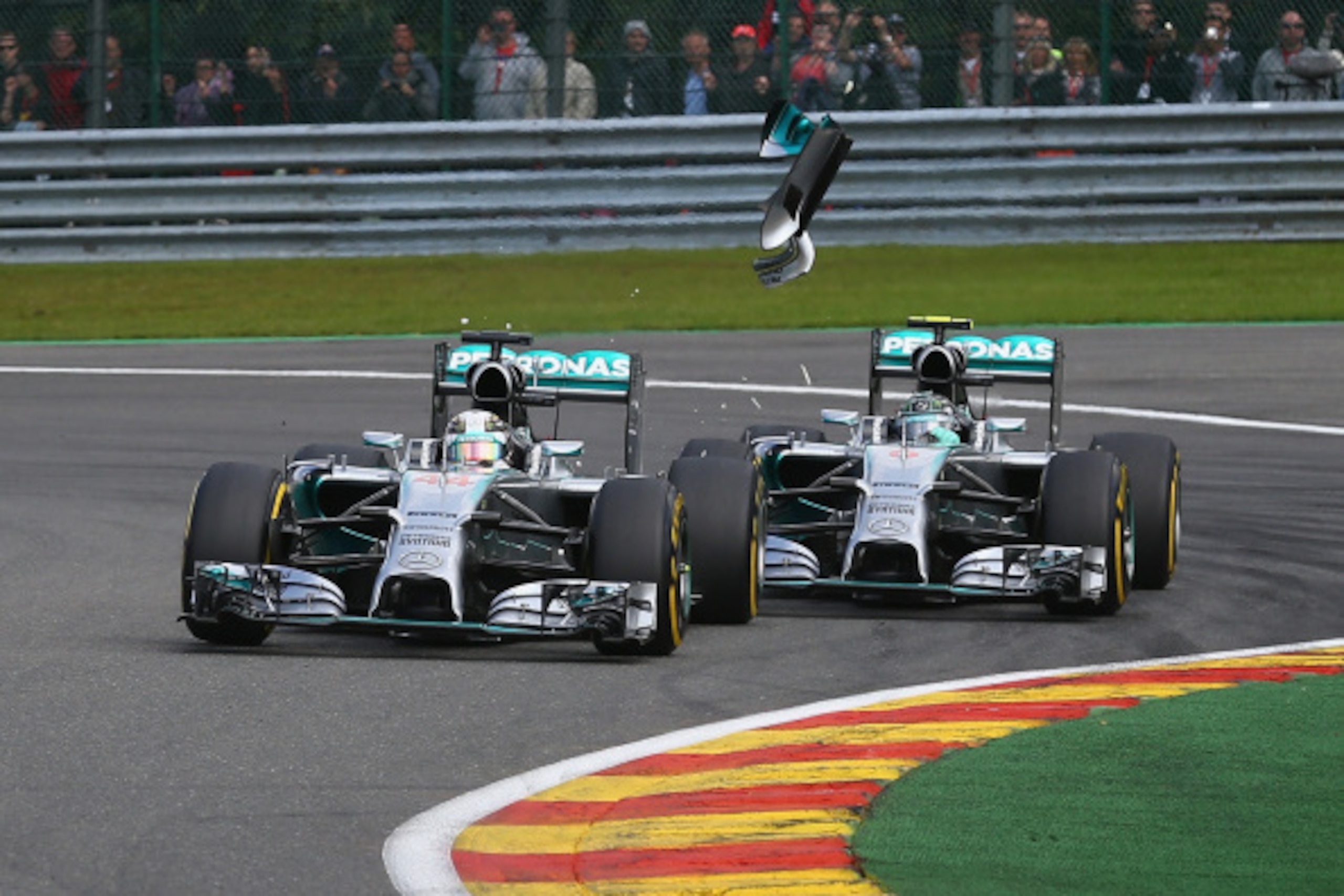 SPA, BELGIUM - AUGUST 24: Debris flies in the air as Nico Rosberg of Germany and Mercedes GP makes contact with Lewis Hamilton of Great Britain and Mercedes GP during the Belgian Grand Prix at Circuit de Spa-Francorchamps on August 24, 2014 in Spa, Belgi SPA, BELGIUM - AUGUST 24: Debris flies in the air as Nico Rosberg of Germany and Mercedes GP makes contact with Lewis Hamilton of Great Britain and Mercedes GP during the Belgian Grand Prix at Circuit de Spa-Francorchamps on August 24, 2014 in Spa, Belgi