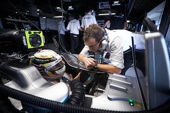 SUZUKA, JAPAN - OCTOBER 07: Lewis Hamilton of Great Britain and Mercedes GP talks with Paul Pezzack, Trackside Control Systems Engineer, Mercedes GP in the garage  during practice for the Formula One Grand Prix of Japan at Suzuka Circuit on October 7, 201