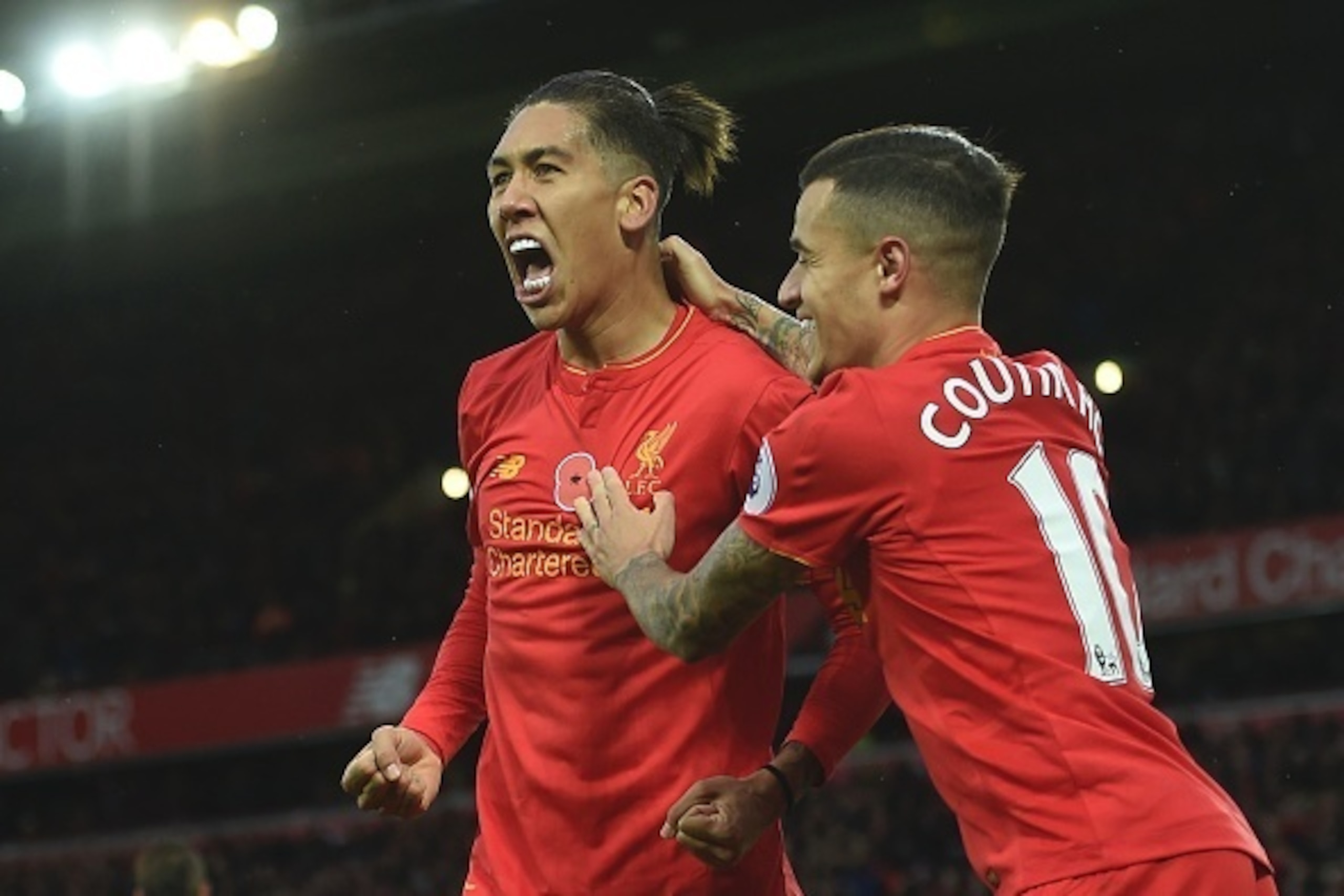 Liverpool's Brazilian midfielder Roberto Firmino (L) celebrates scoring his team's fourth goal with Liverpool's Brazilian midfielder Philippe Coutinho during the English Premier League football match between Liverpool and Watford at Anfield in Liverpool, 