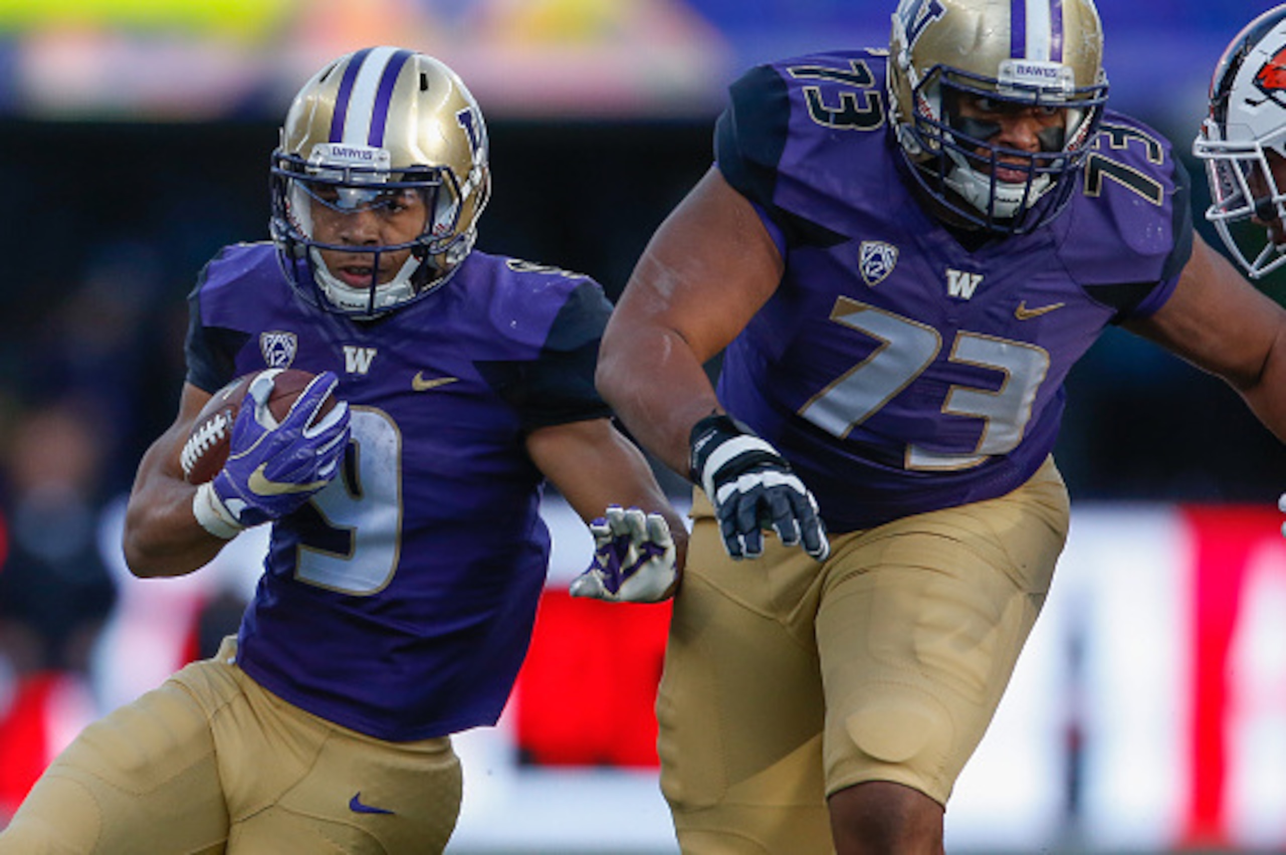 SEATTLE, WA - OCTOBER 22:  Running back Myles Gaskin #9 of the Washington Huskies rushes behind the block of Andrew Kirkland #73 against the Oregon State Beavers on October 22, 2016 at Husky Stadium in Seattle, Washington. The Huskies defeated the Beavers