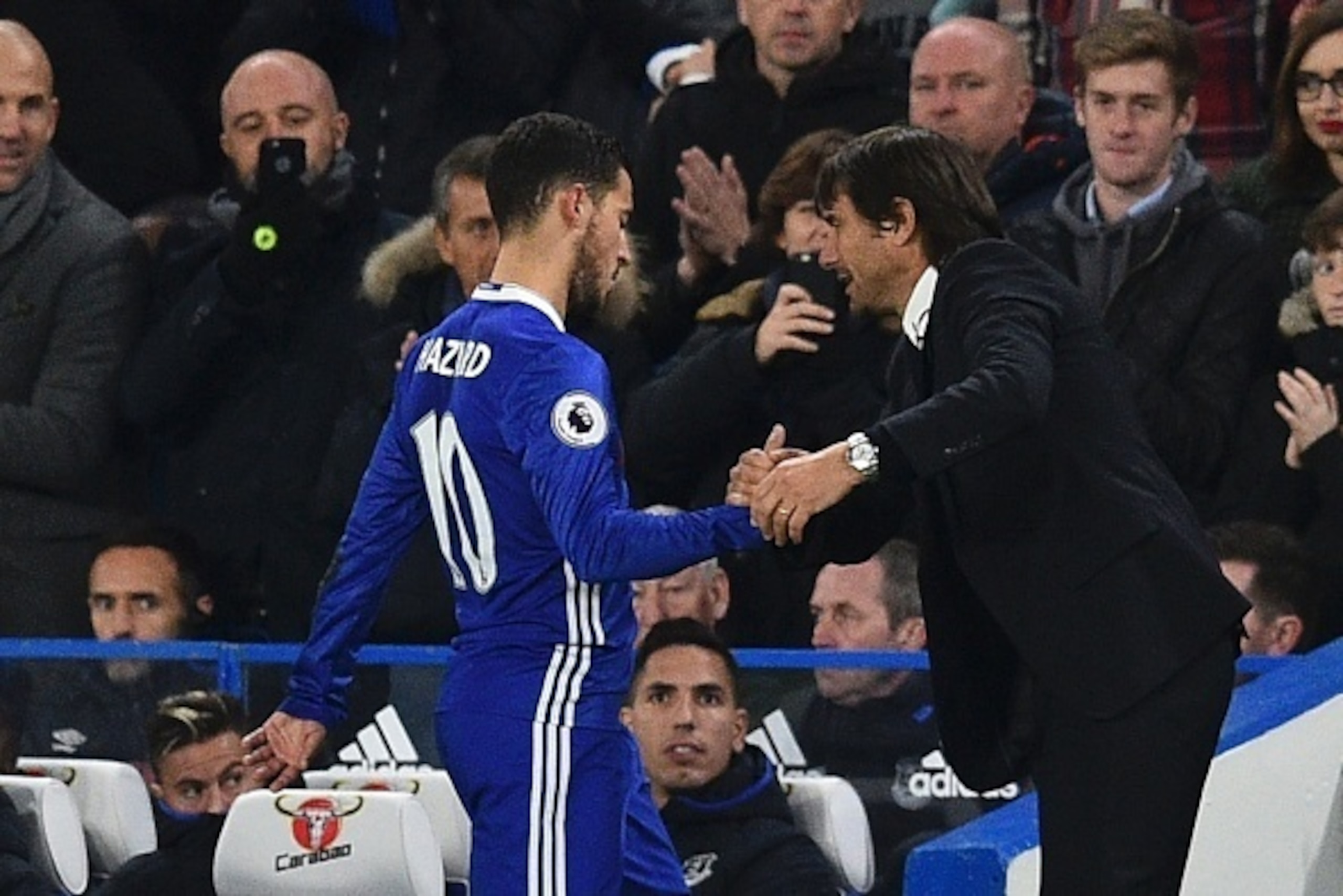 Chelsea's Belgian midfielder Eden Hazard shakes the hand of Chelsea's Italian head coach Antonio Conte (R) after being substituted during the English Premier League football match between Chelsea and Everton at Stamford Bridge in London on November 5, 201