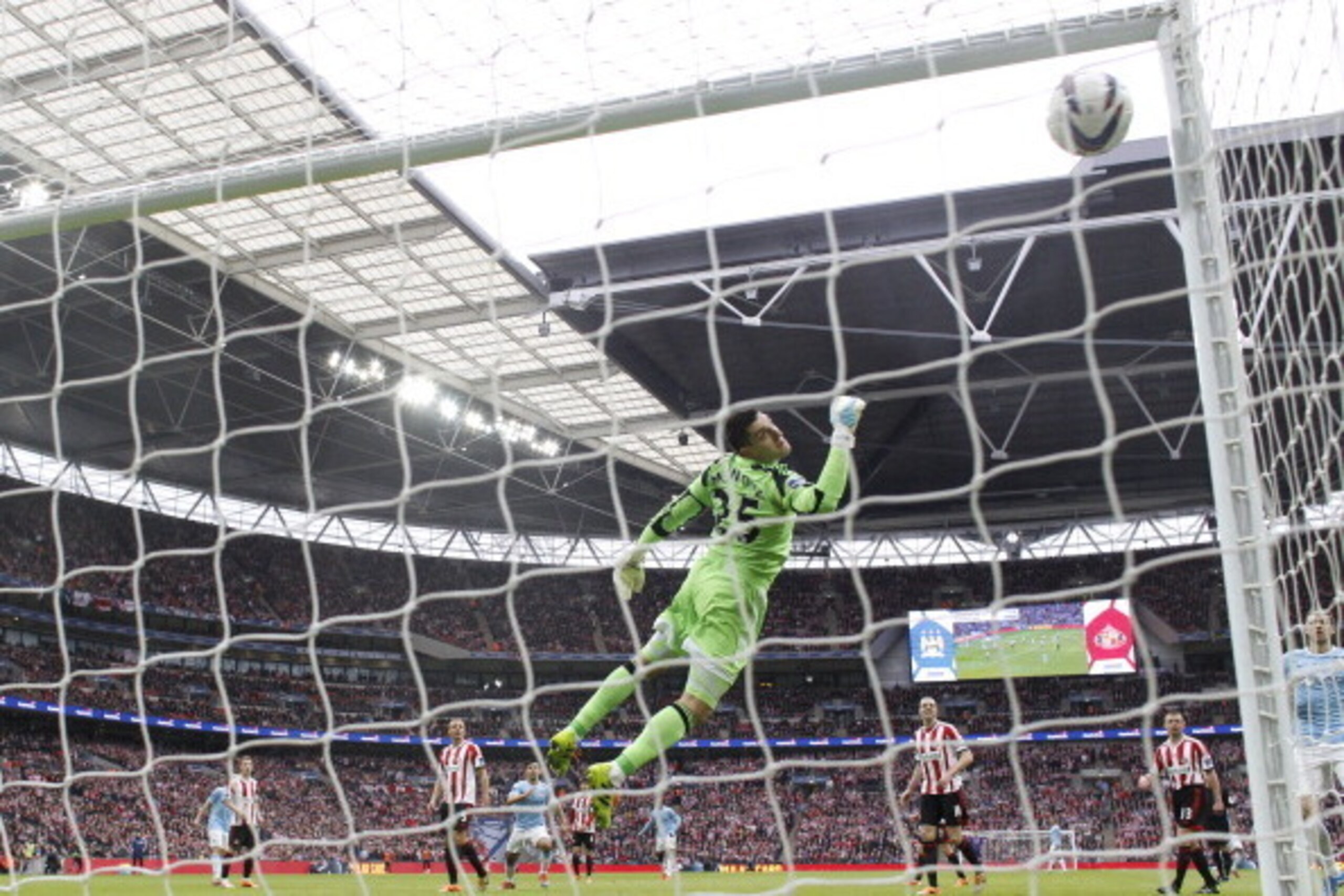 Sunderland's Italian goalkeeper Vito Mannone (C) dives in vain as the ball goes into the top corner of his goal from a strike by Manchester City's Ivorian midfielder Yaya Toure for Manchester City's first goal during the League Cup final football match be