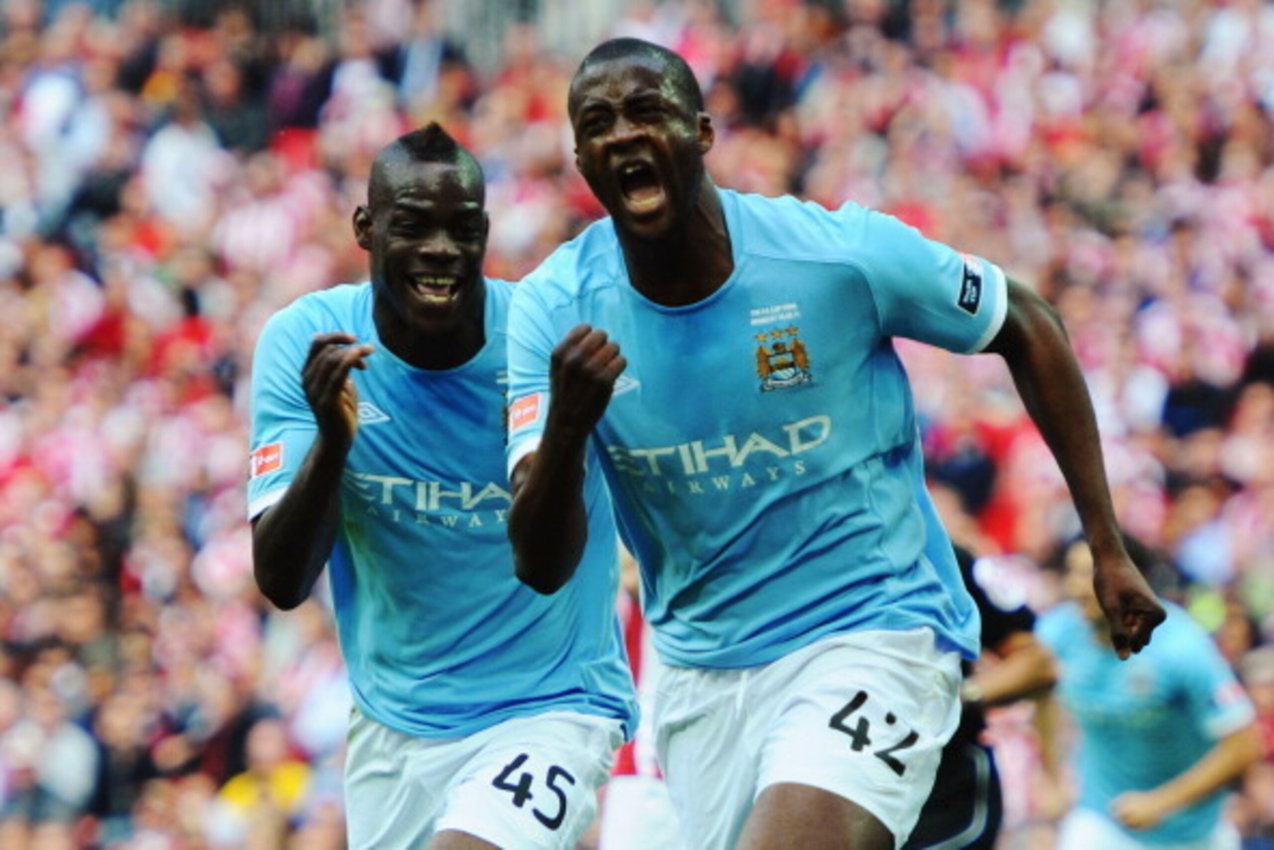 LONDON, ENGLAND - MAY 14:  Yaya Toure (R) of Manchester City celebrates with Mario Balotelli (L) after scoring during the FA Cup sponsored by E.ON Final match between Manchester City and Stoke City at Wembley Stadium on May 14, 2011 in London, England.  (