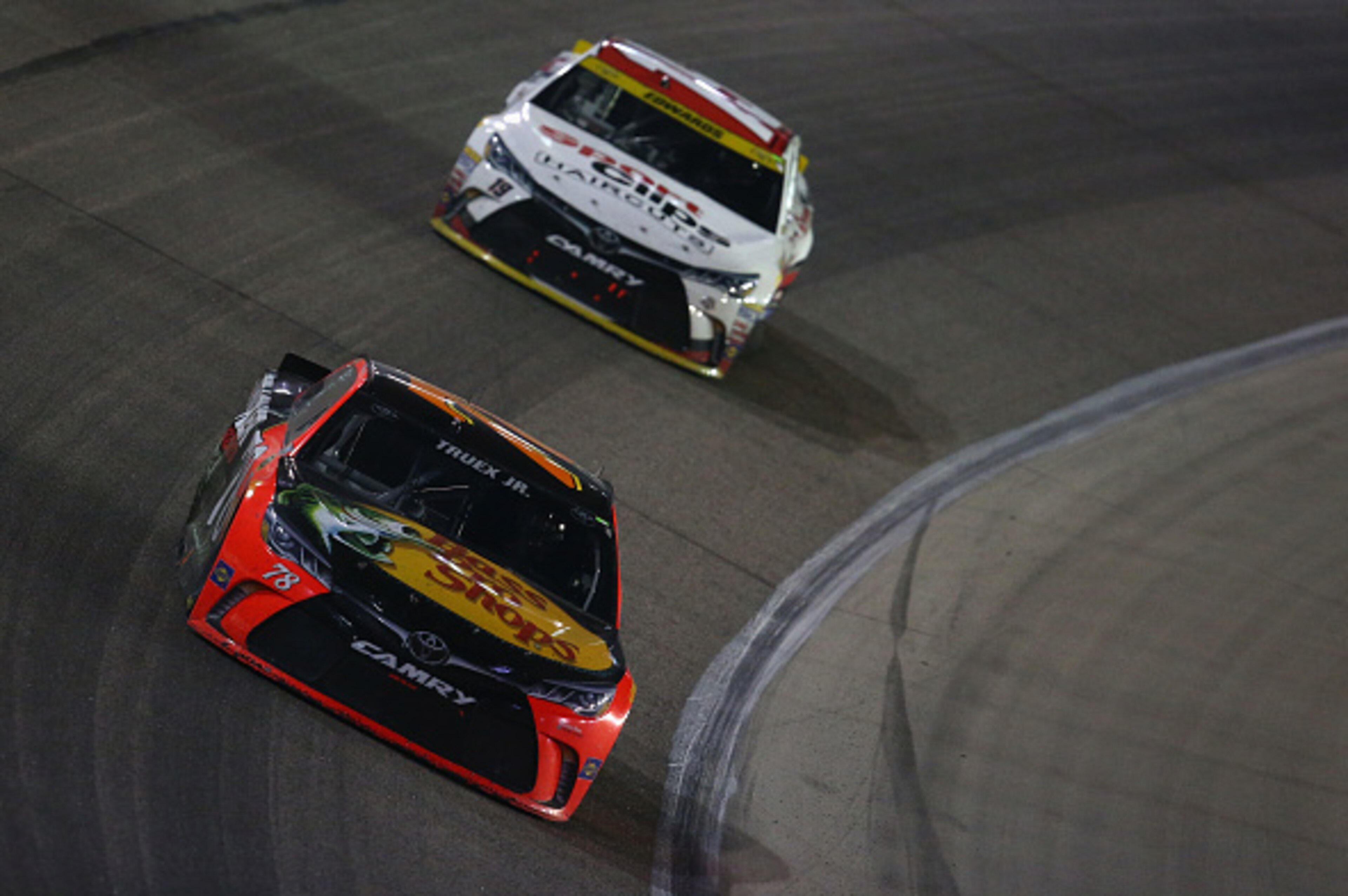 FORT WORTH, TX - NOVEMBER 06:  Martin Truex Jr., driver of the #78 Bass Pro Shops/TRACKER Boats Toyota, leads Carl Edwards, driver of the #19 Sport Clips Toyota, during the NASCAR Sprint Cup Series AAA Texas 500 at Texas Motor Speedway on November 6, 2016