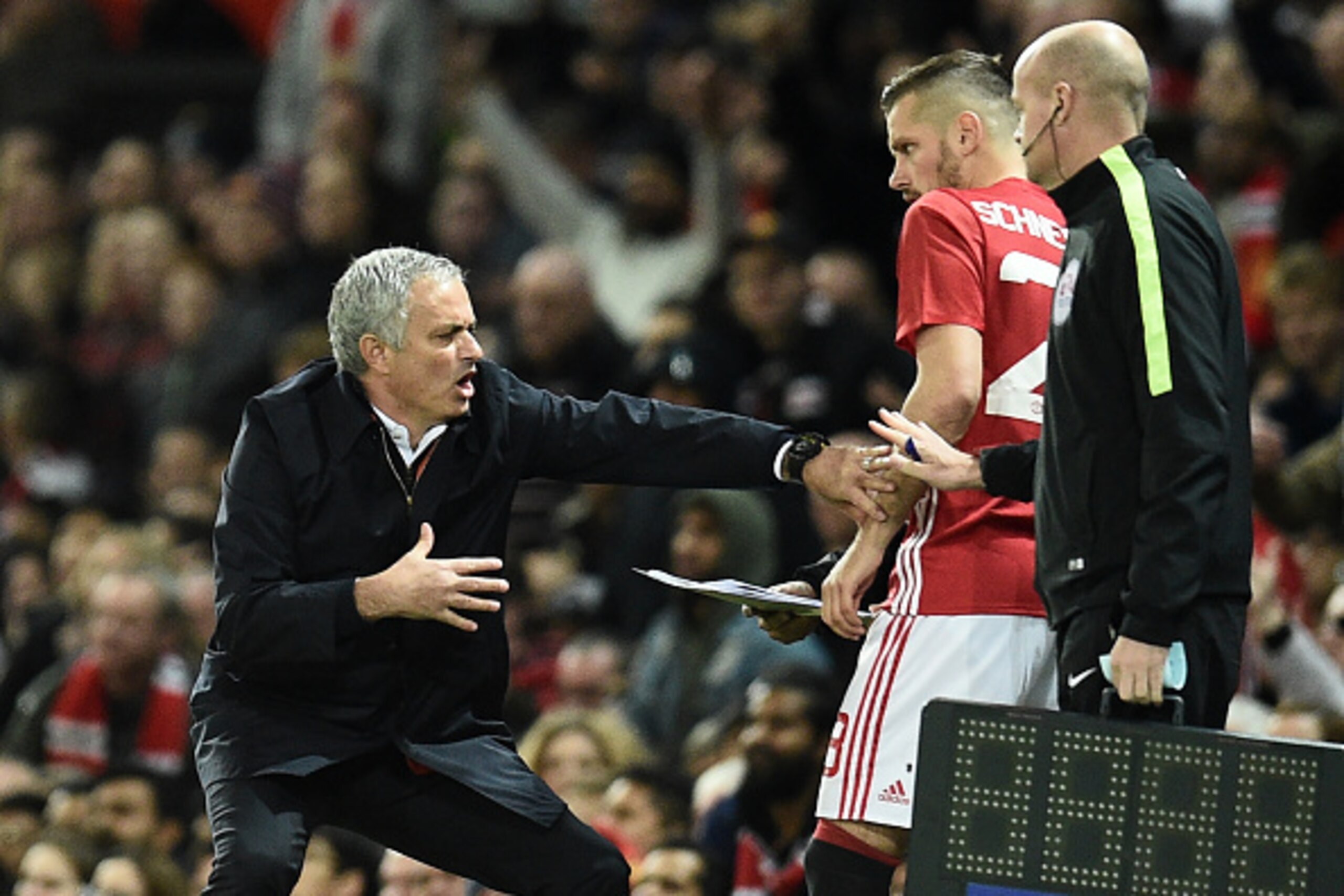 Manchester United's Portuguese manager Jose Mourinho gestures as Manchester United's French midfielder Morgan Schneiderlin prepares to come on as substitute during the EFL (English Football League) Cup fourth round match between Manchester United and Manc