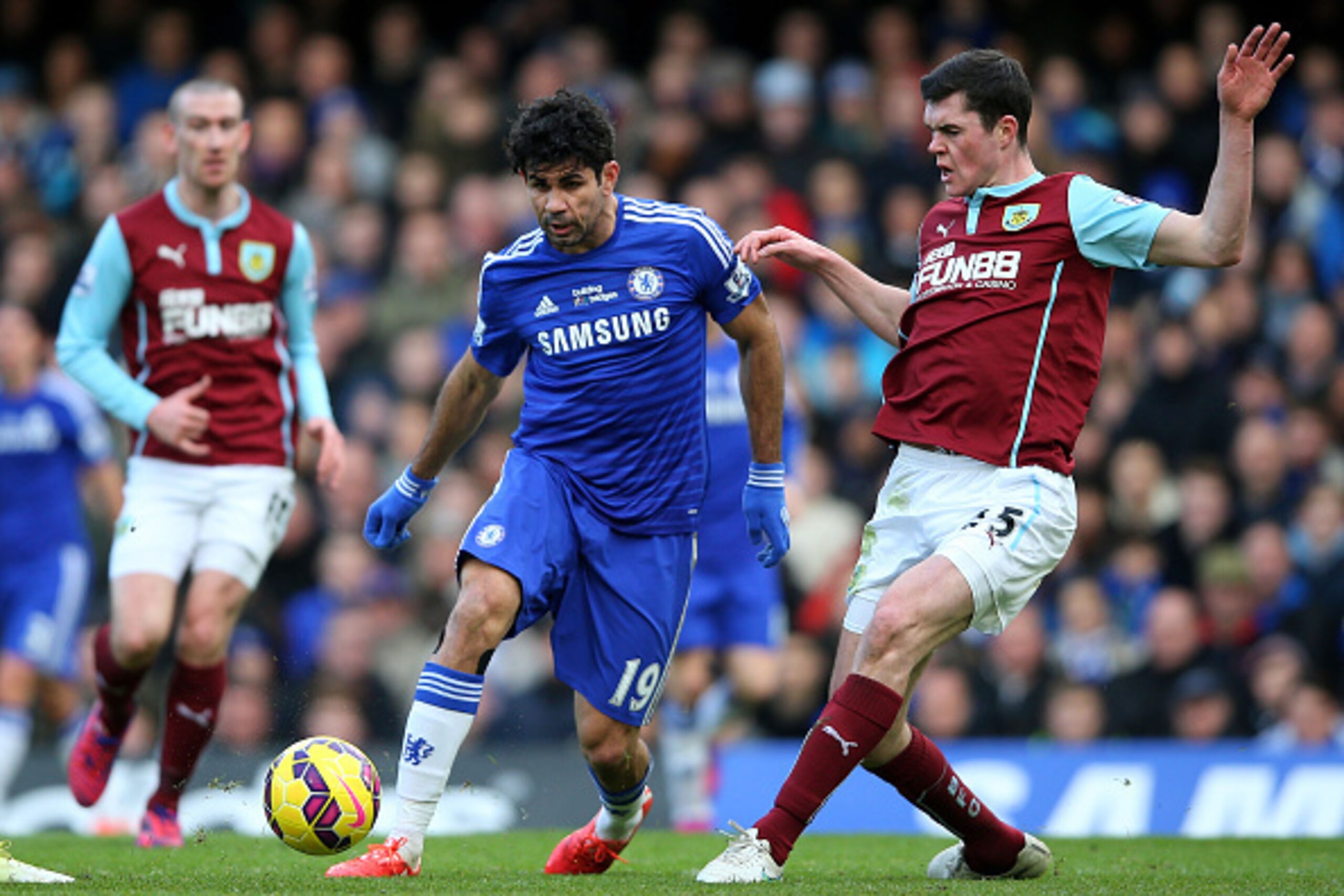 LONDON, ENGLAND - FEBRUARY 21: Diego Costa of Chelsea is tackled by Michael Keane of Burnley during the Barclays Premier League match between Chelsea and Burnley at Stamford Bridge on February 21, 2015 in London, England. (Photo by Paul Gilham/Getty Ima LONDON, ENGLAND - FEBRUARY 21: Diego Costa of Chelsea is tackled by Michael Keane of Burnley during the Barclays Premier League match between Chelsea and Burnley at Stamford Bridge on February 21, 2015 in London, England. (Photo by Paul Gilham/Getty Ima
