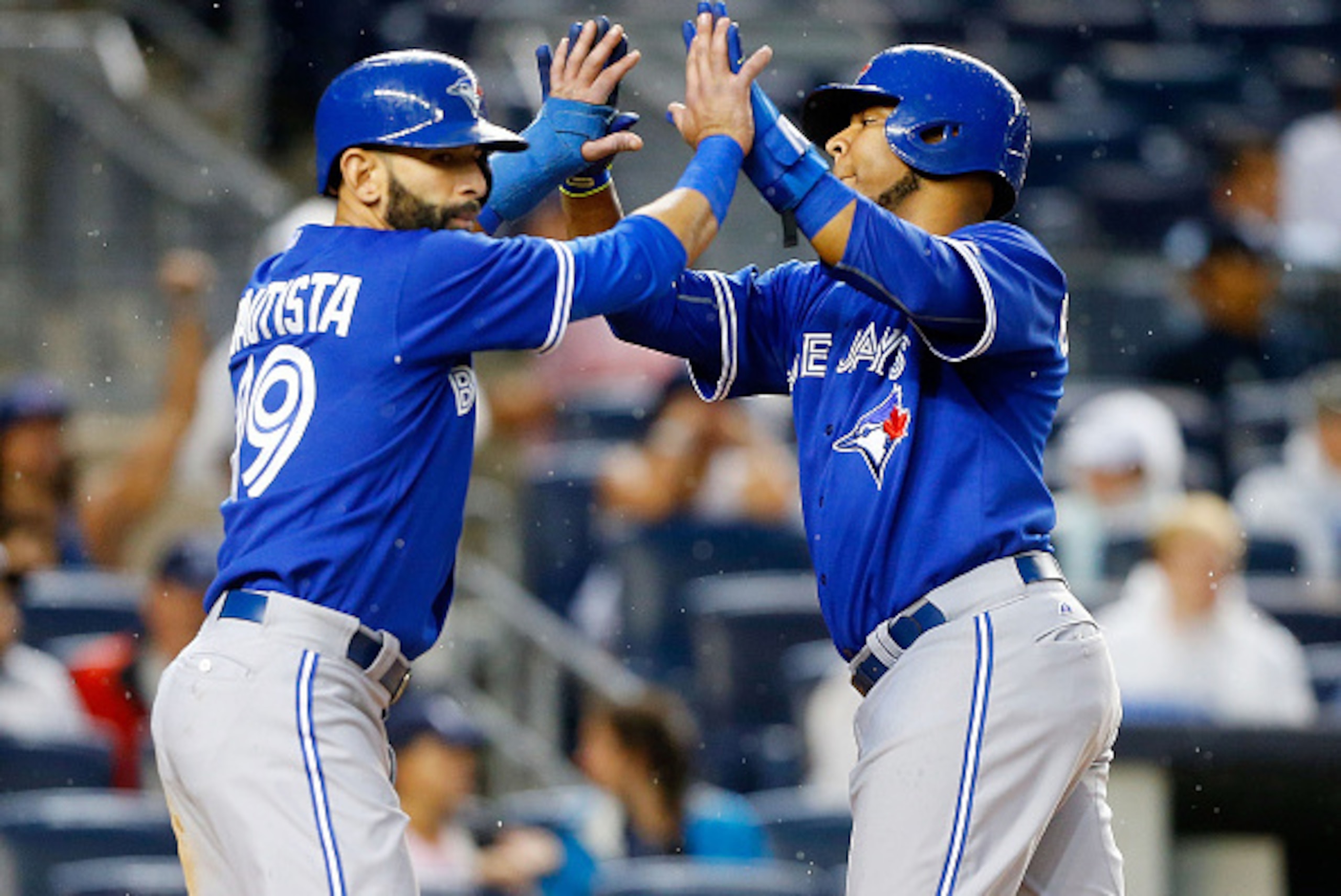 NEW YORK, NY - SEPTEMBER 12:  Edwin Encarnacion #10 and Jose Bautista #19 of the Toronto Blue Jays celebrate after both scored runs in the second inning against the New York Yankees after a double from teammate Russell Martin (not pictured) at Yankee Stad