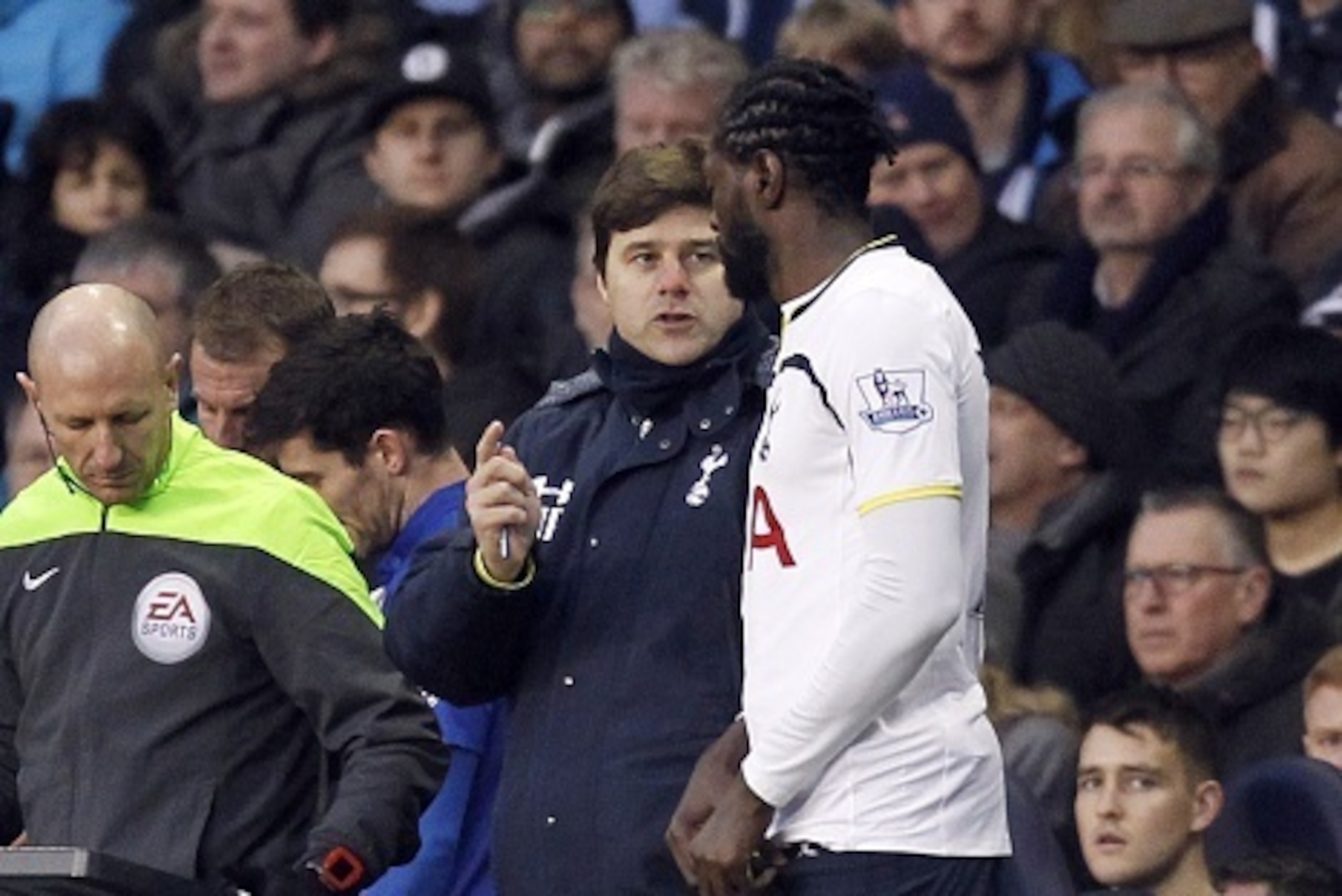 Tottenham Hotspurs Argentinian head coach Mauricio Pochettino talks to Tottenham Hotspur's Togolese striker Emmanuel Adebayor before he comes on as a substitute during the FA Cup fourth round football match between Tottenham Hotspur and Leicester City at 