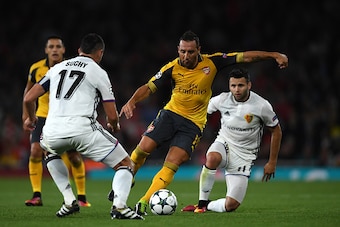 LONDON, ENGLAND - SEPTEMBER 28:  Santi Cazorla of Arsenal battles for the ball with Marek Suchy and Renato Steffen of Basel during the UEFA Champions League group A match between Arsenal FC and FC Basel 1893 at the Emirates Stadium on September 28, 2016 i