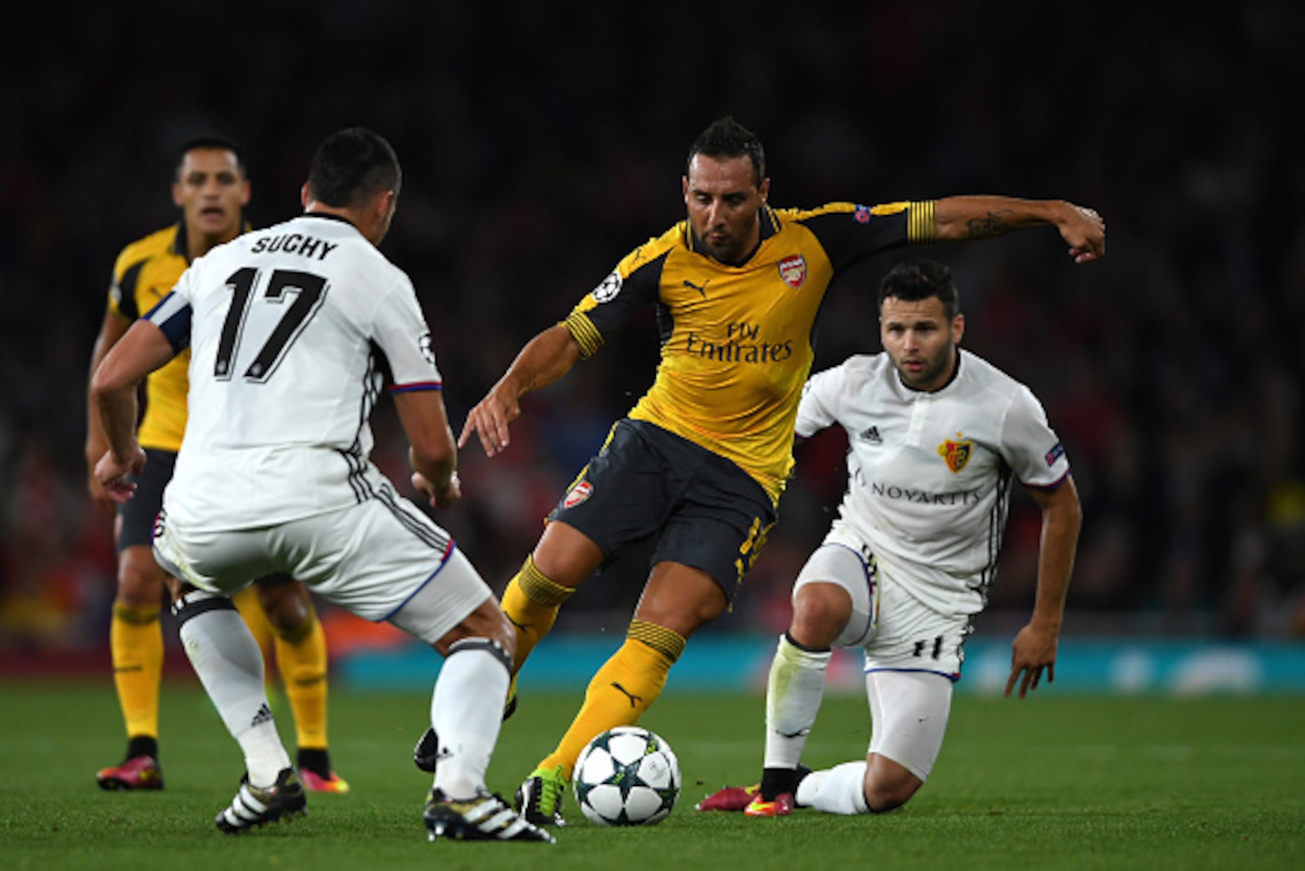 LONDON, ENGLAND - SEPTEMBER 28:  Santi Cazorla of Arsenal battles for the ball with Marek Suchy and Renato Steffen of Basel during the UEFA Champions League group A match between Arsenal FC and FC Basel 1893 at the Emirates Stadium on September 28, 2016 i